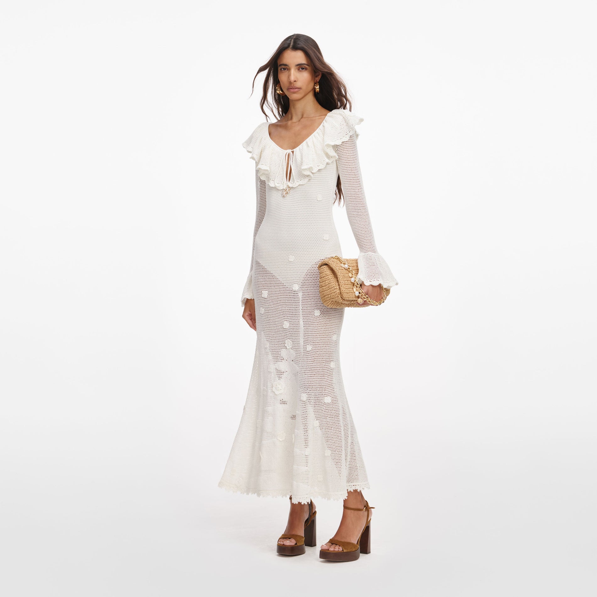 Side view of a woman wearing the White Floral Crochet Midi Dress