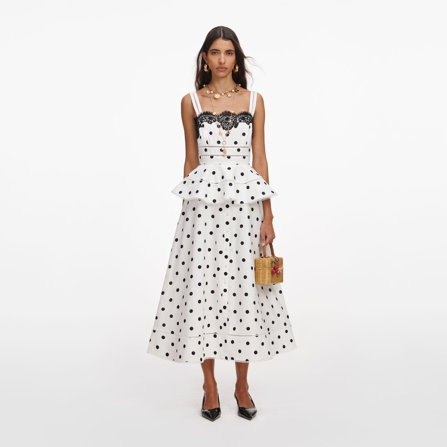 Front view of a woman wearing the White Polka Dot Linen Midi Dress