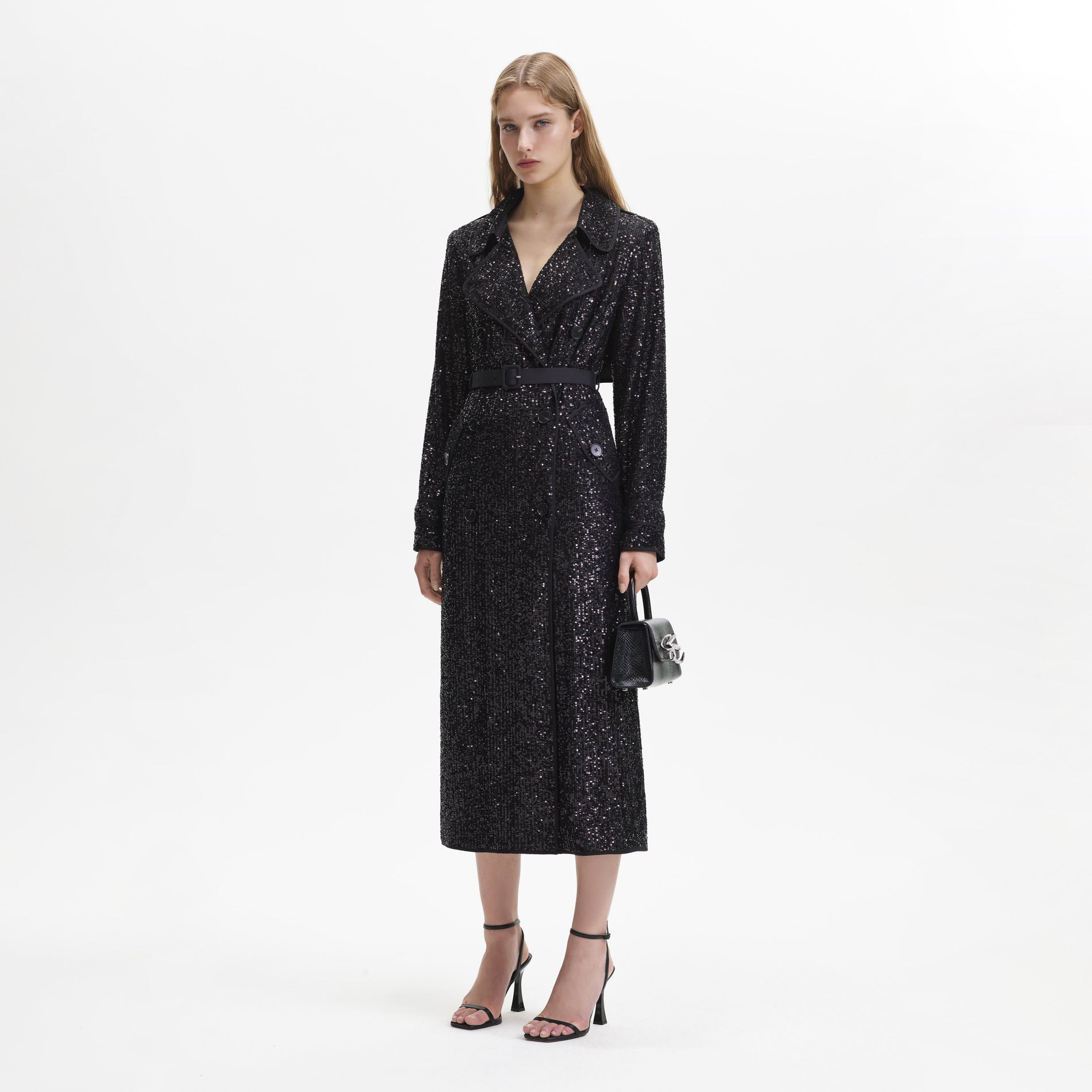 Side view of a woman wearing the Black Sequin Trench Coat