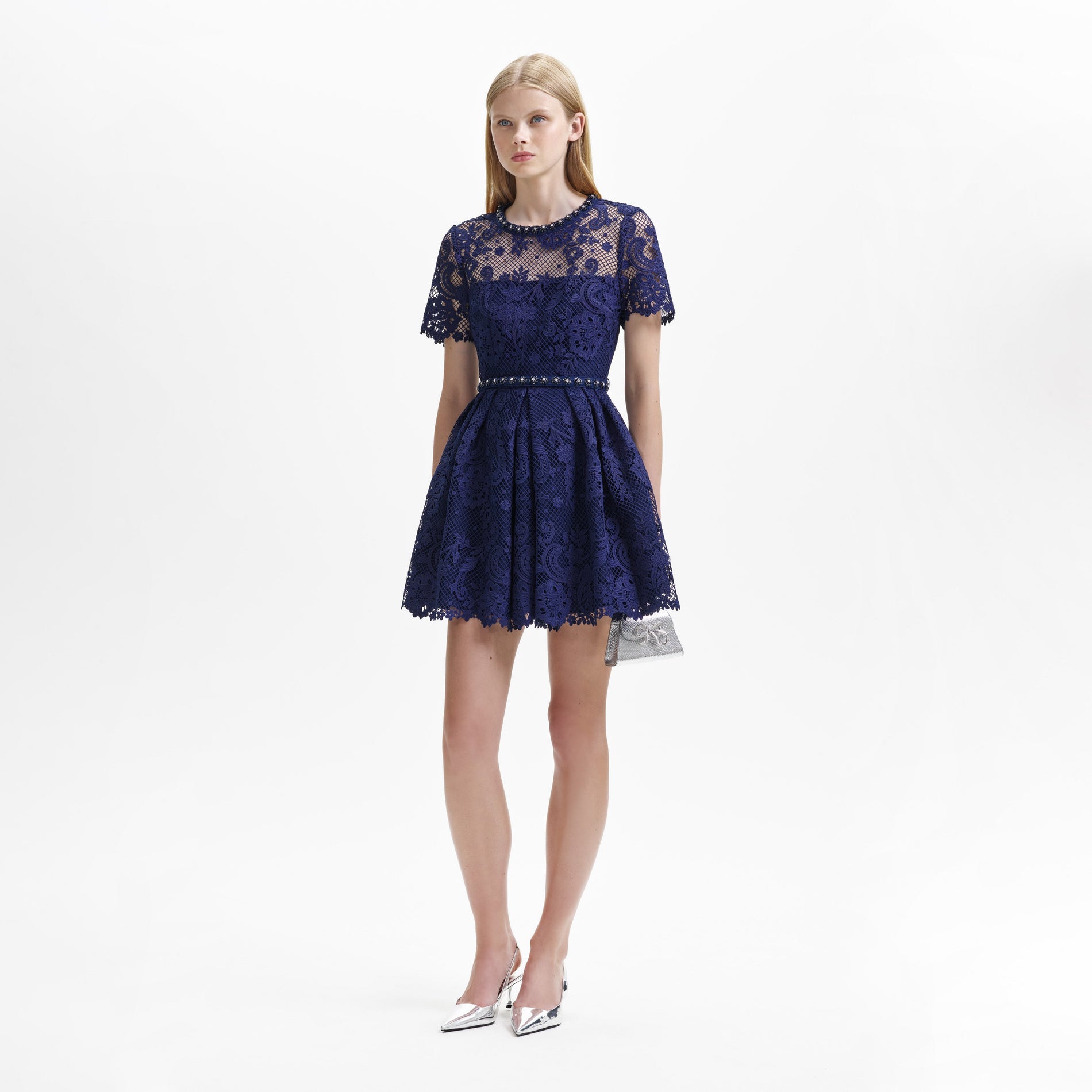 Side view of a woman wearing the Navy Lace Embellished Mini Dress