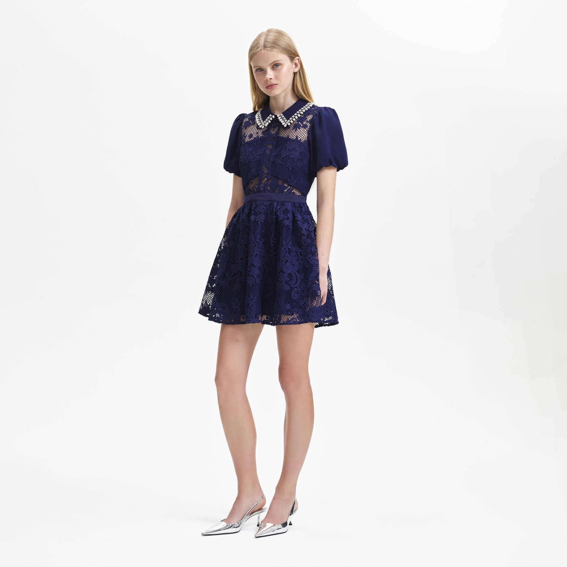 A woman wearing the Navy Lace Diamante Collar Mini Dress