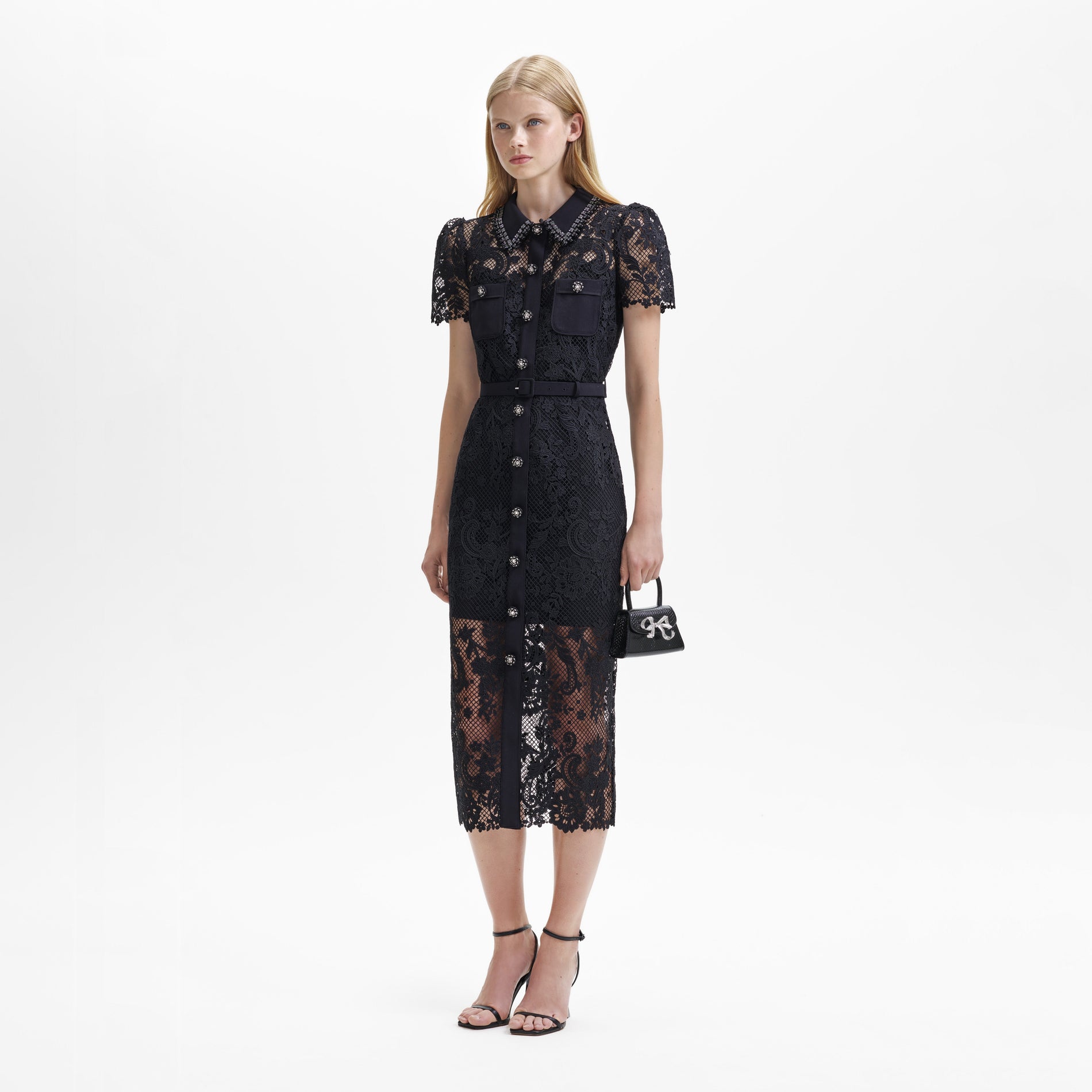 A woman wearing the Black Lace Button Front Midi Dress