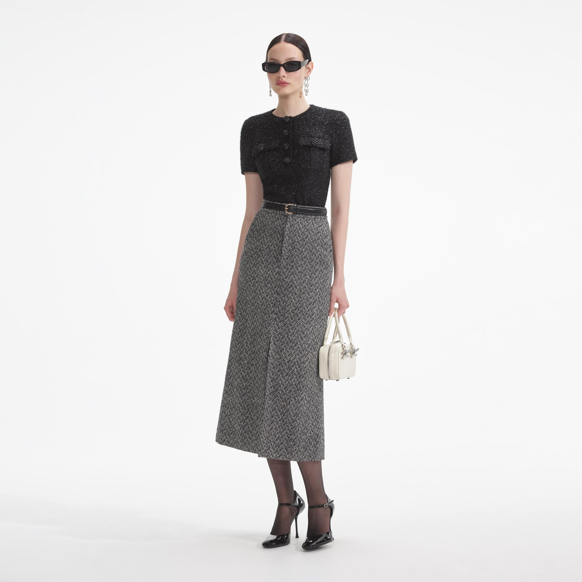 Side view of a woman wearing the Black Tinsel Boucle Top