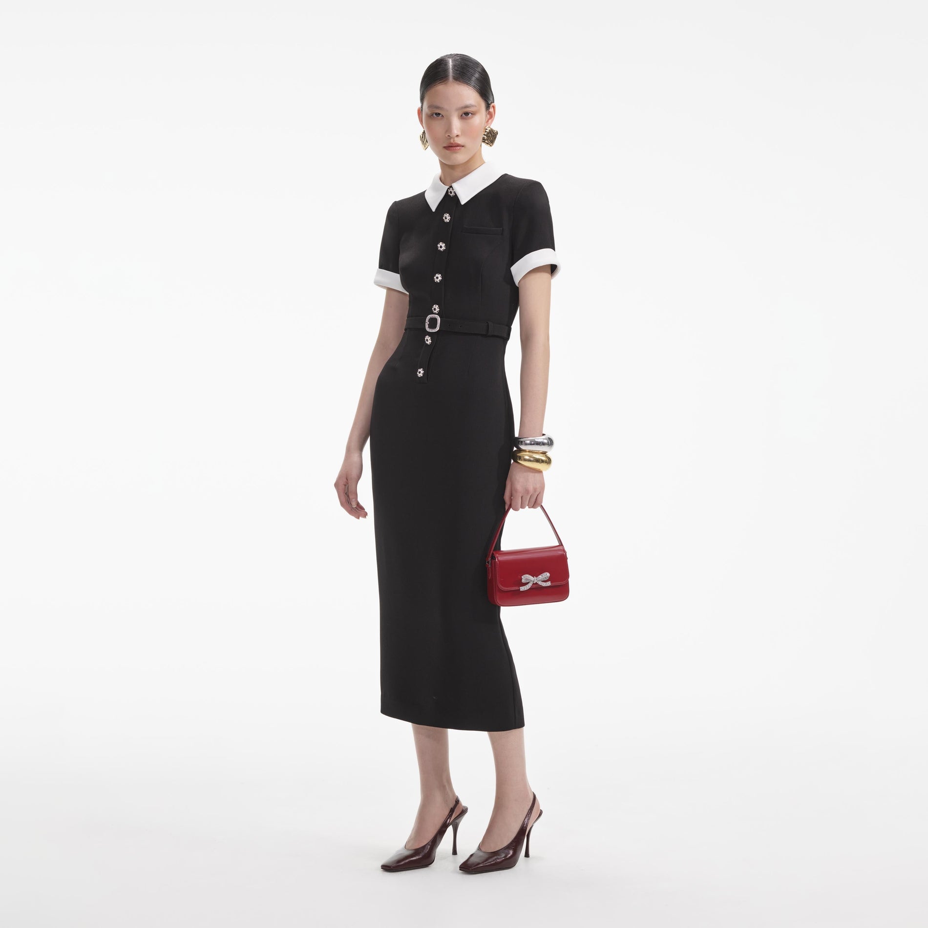 Side view of a woman wearing the Black Crepe Contrast Midi Dress