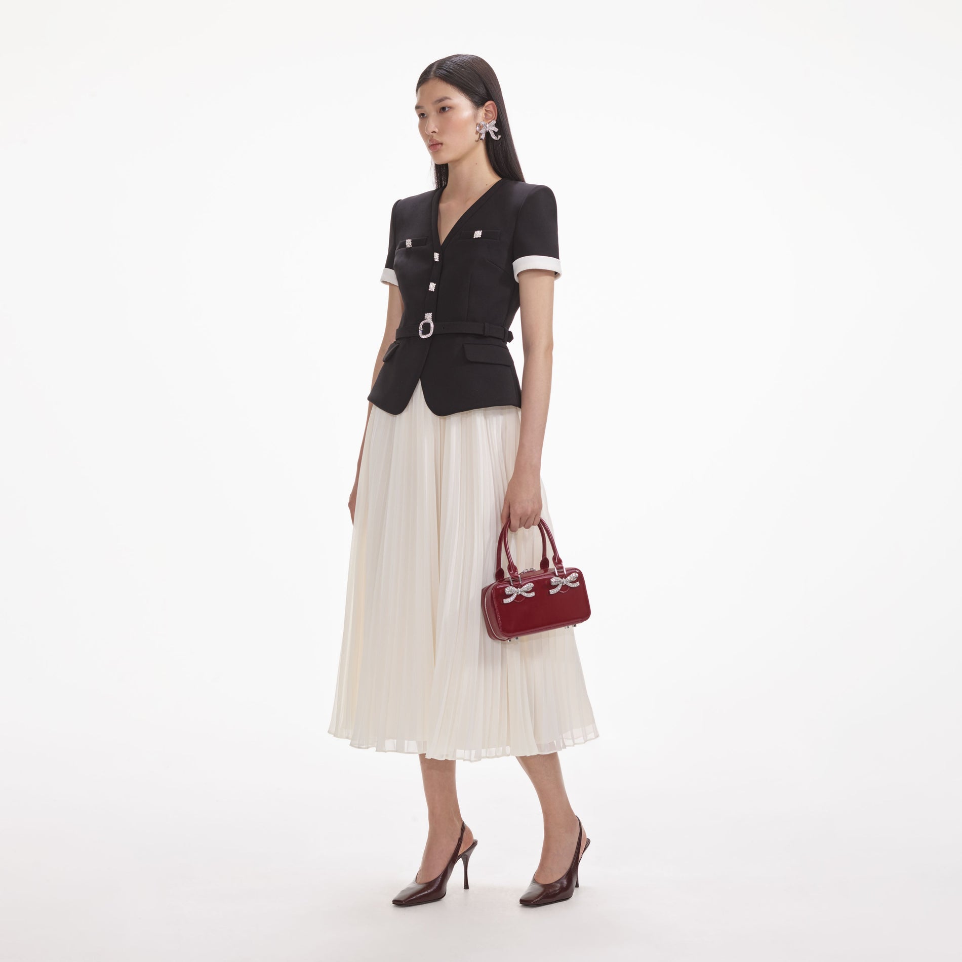 Side view of a woman wearing the Black Crepe Contrast Chiffon Midi Dress