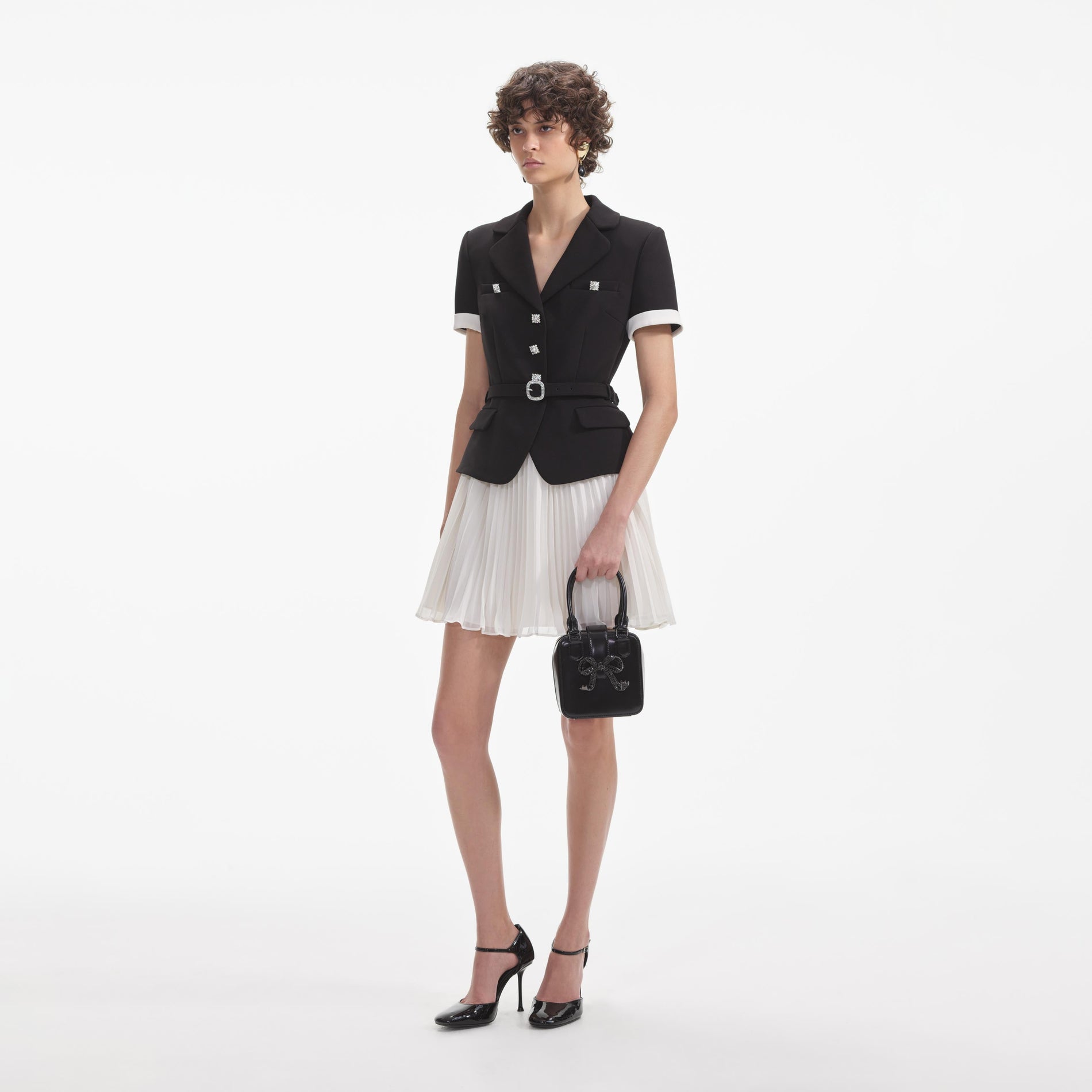 Side view of a woman wearing the Black Crepe Contrast Chiffon Mini Dress