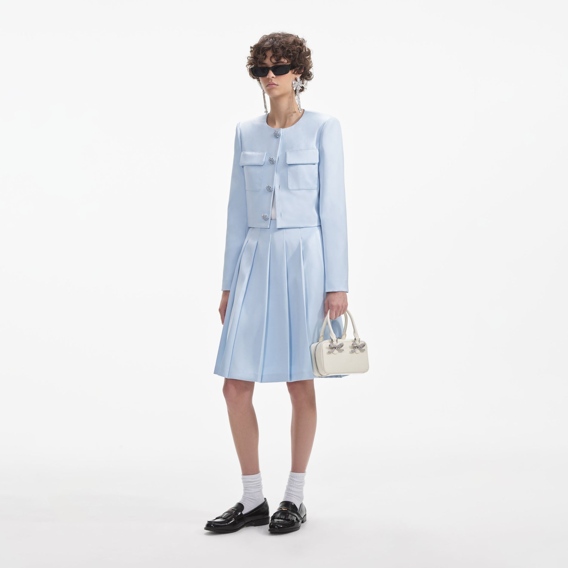 Side view of a woman wearing the Blue Satin Jacket