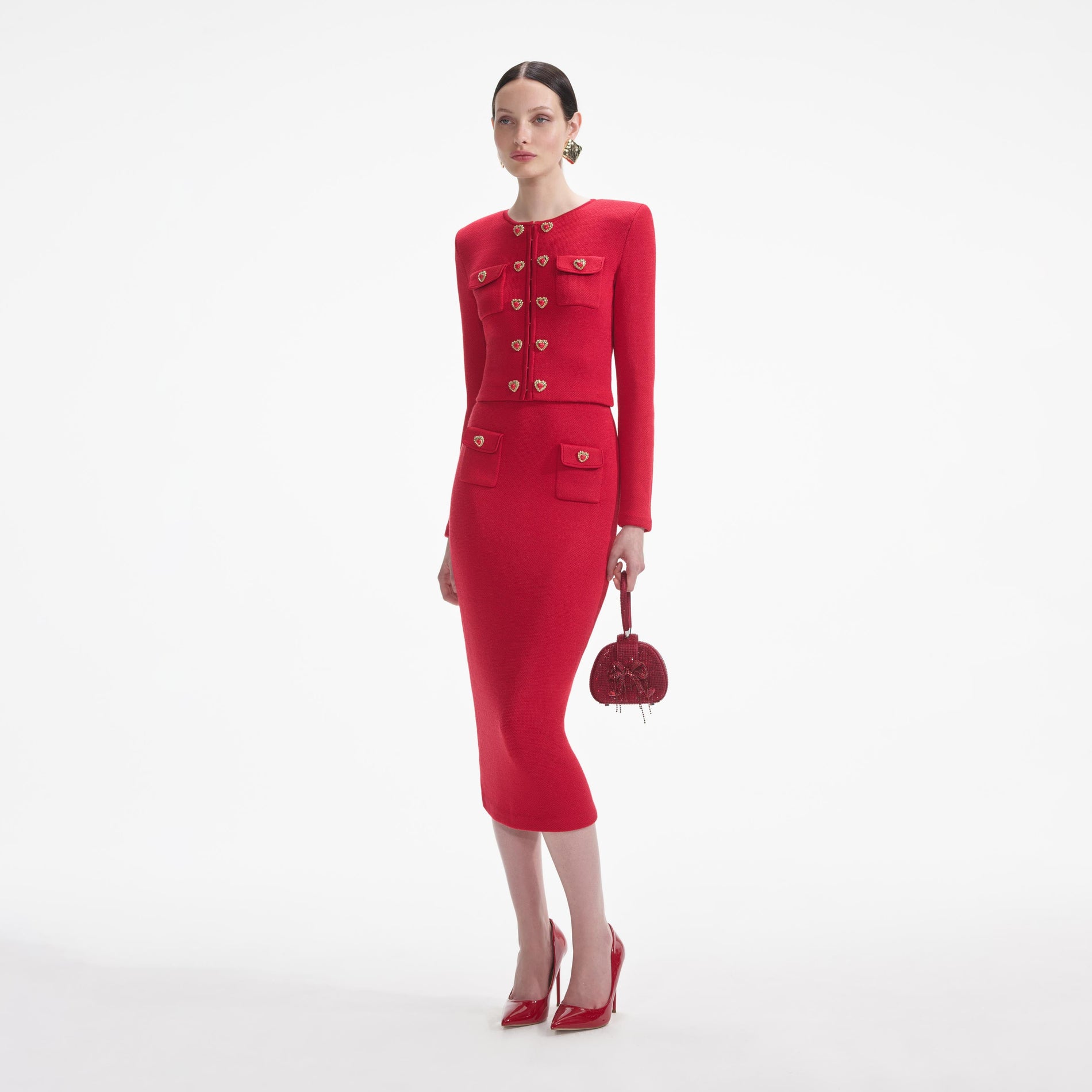Side view of a woman wearing the Red Knit Heart Buttoned Midi Skirt