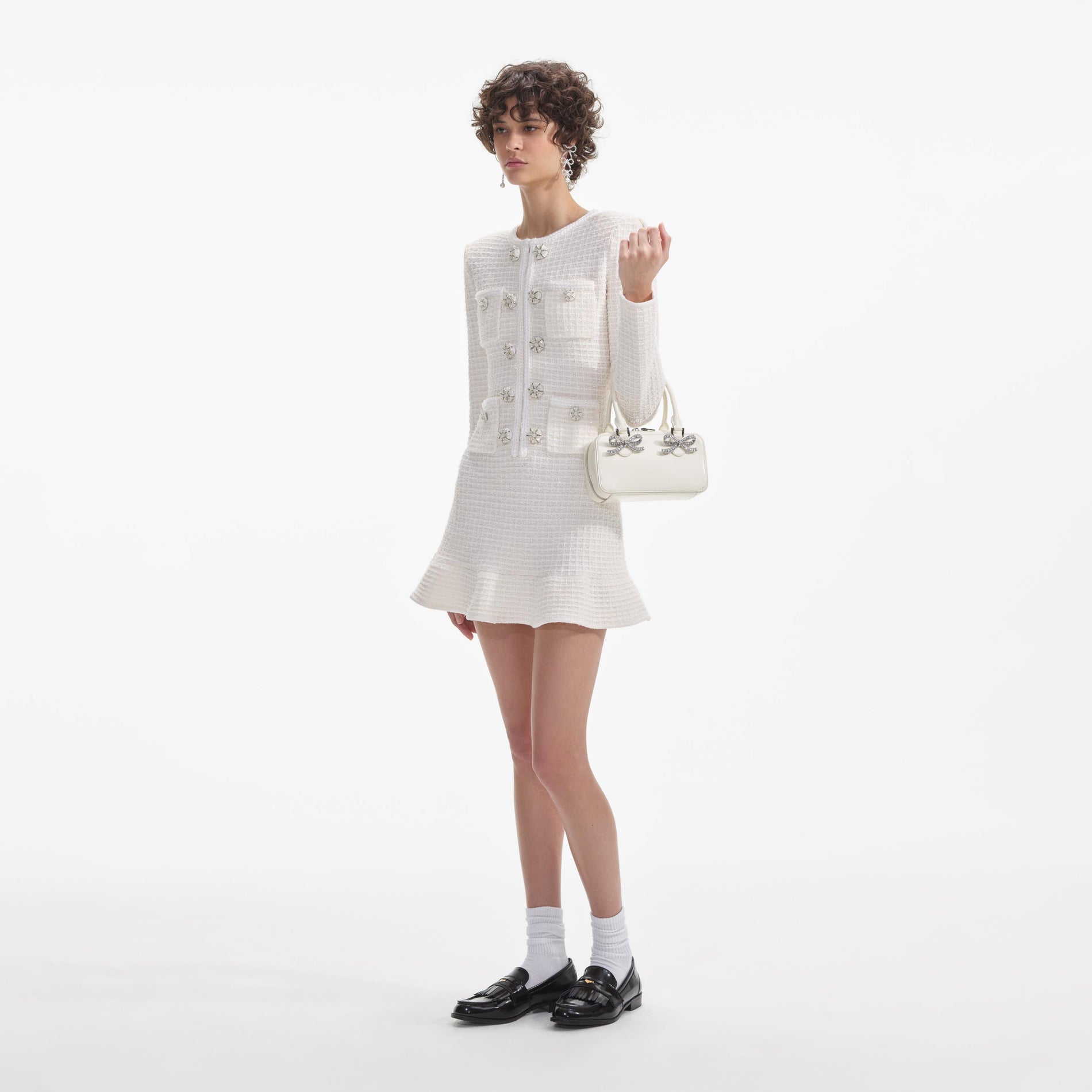 Side view of a woman wearing the Cream Buttoned Knit Mini Dress