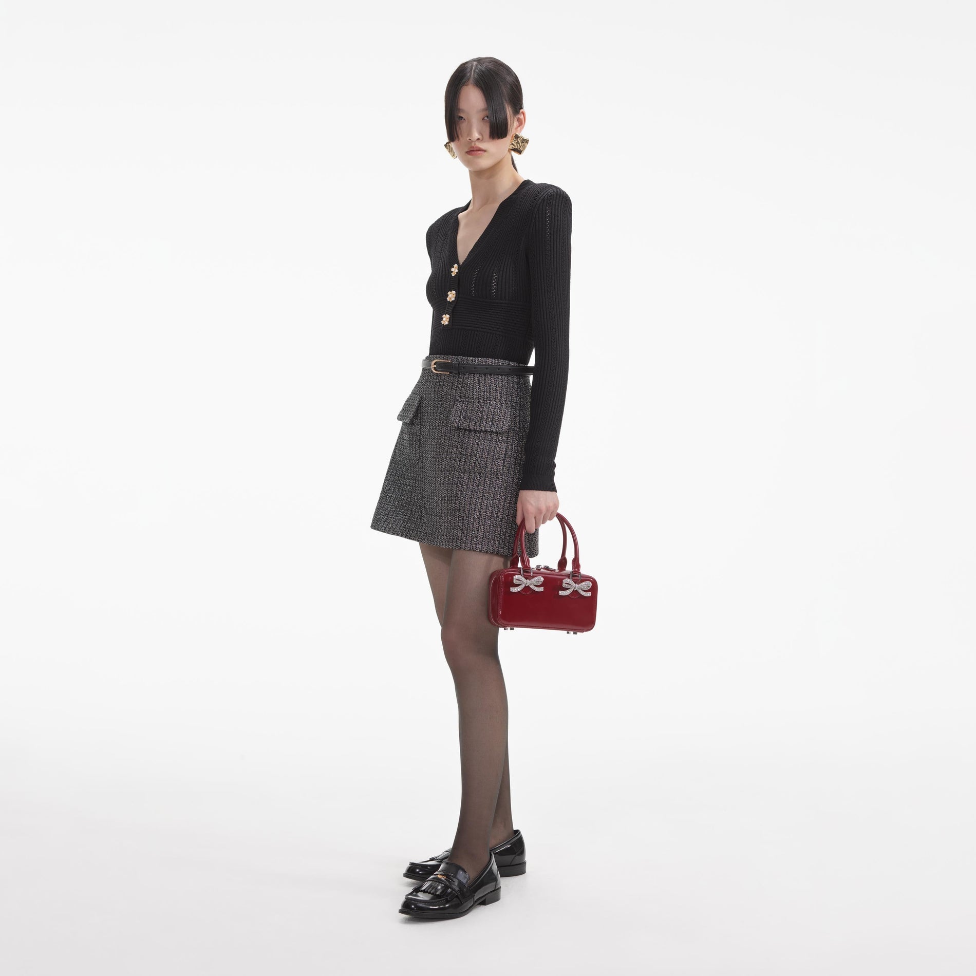 Side view of a woman wearing the Black Pointelle Knit Top