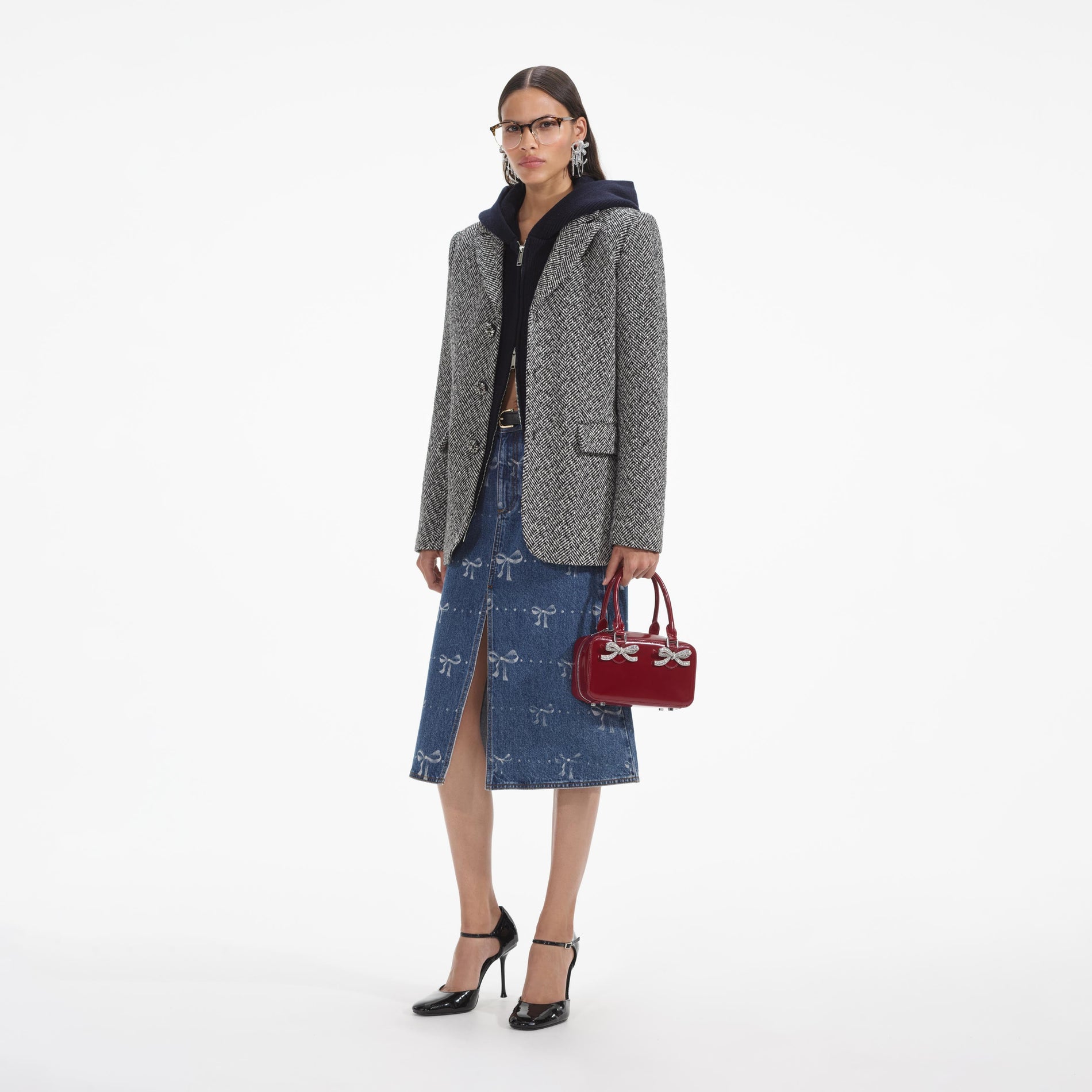 Side view of a woman wearing the Black Herringbone Blazer