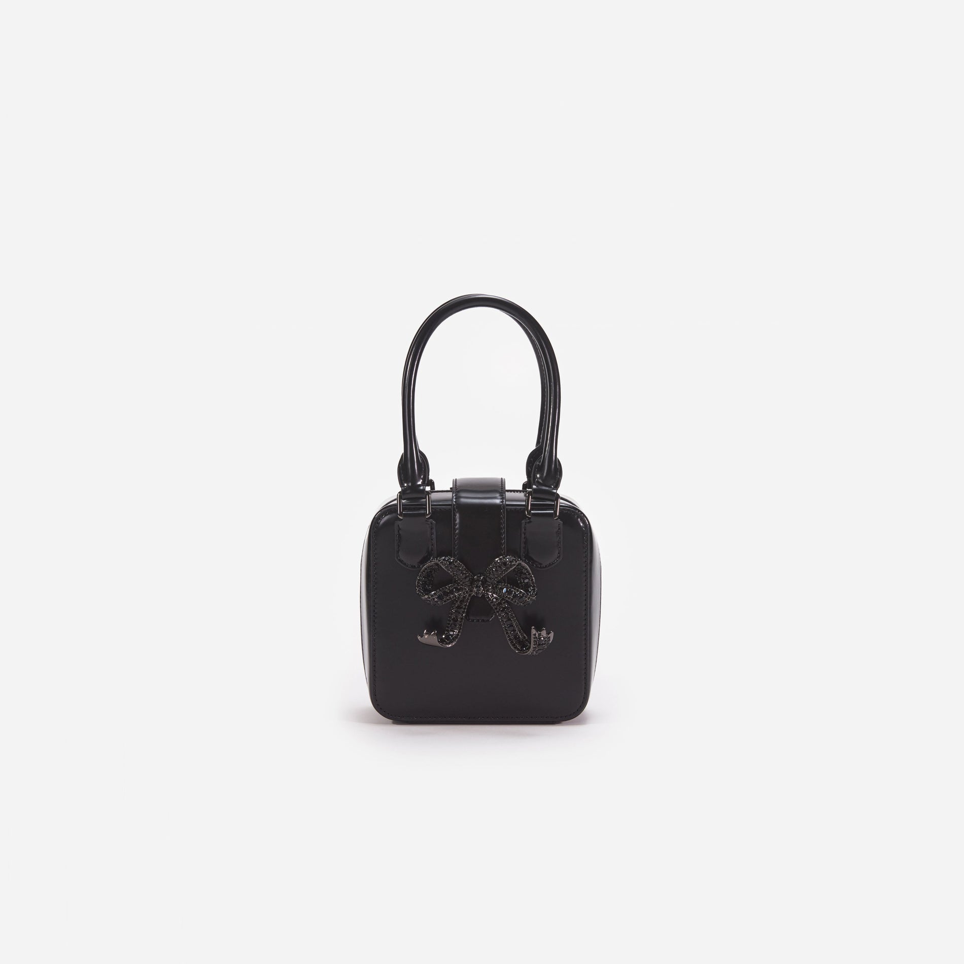 Front view of a woman wearing the Black Leather Square Mini Tote Bag