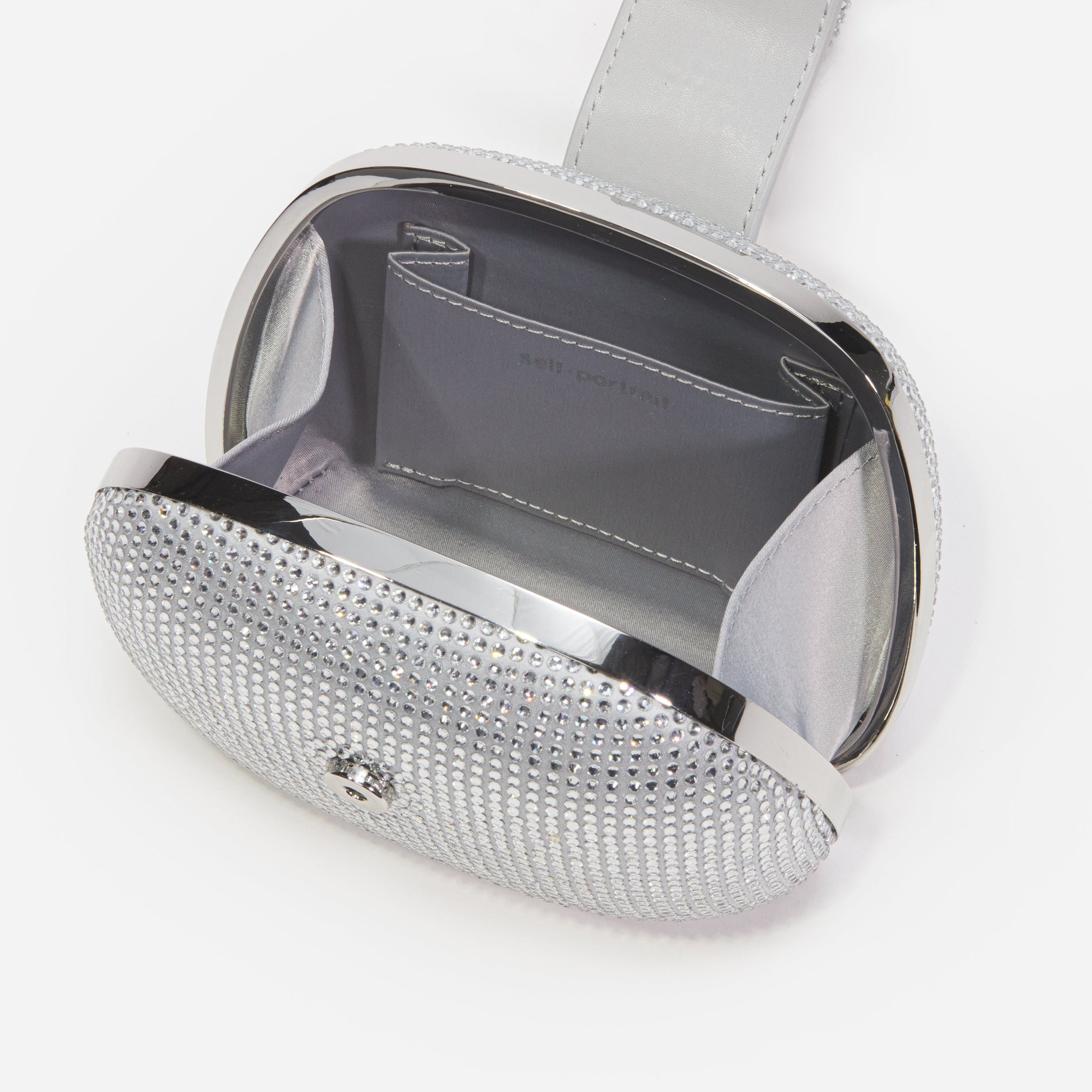 A close up of a woman wearing the Silver Rhinestone Top Handle Clutch Bag