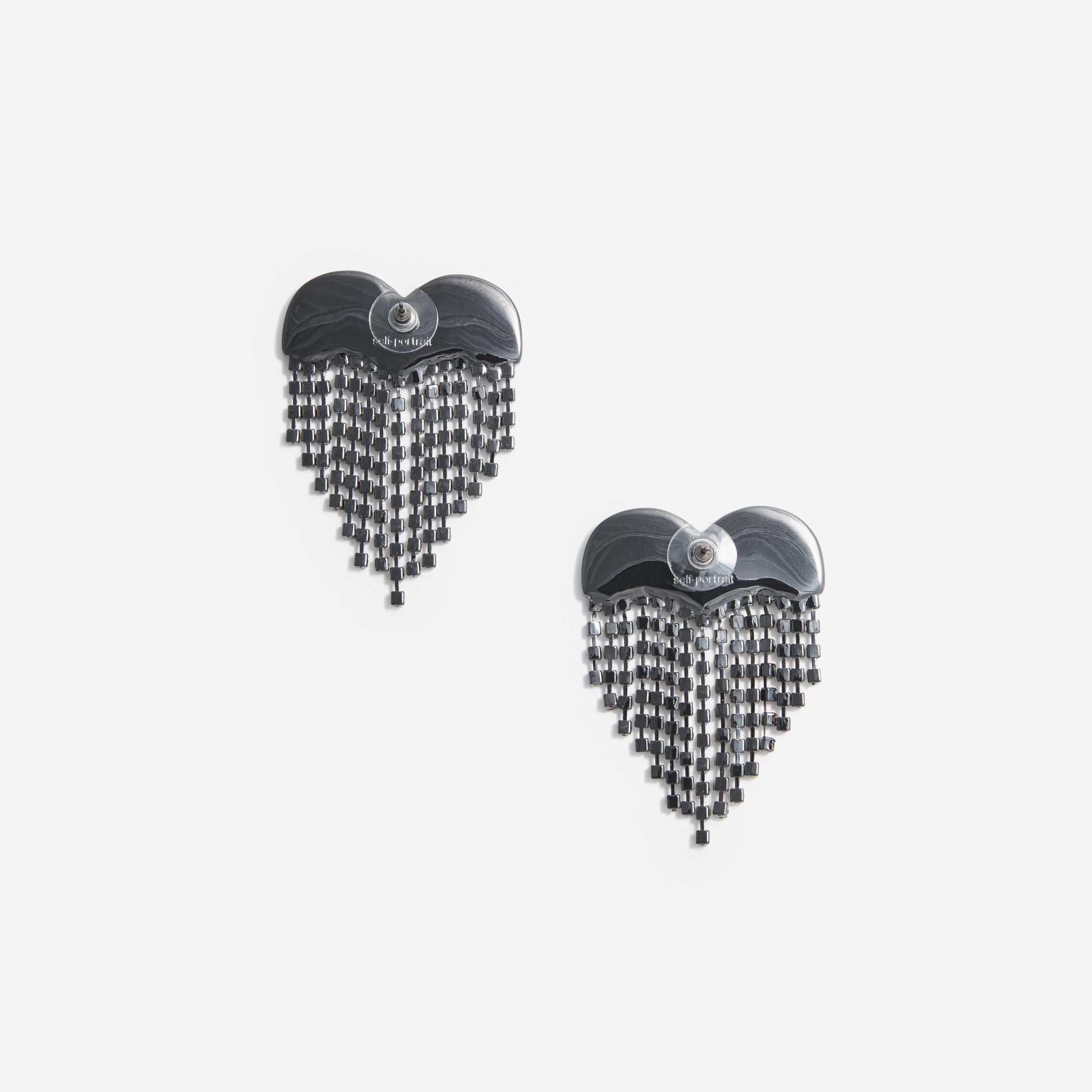 Side view of a woman wearing the Smoke Crystal Heart Earrings