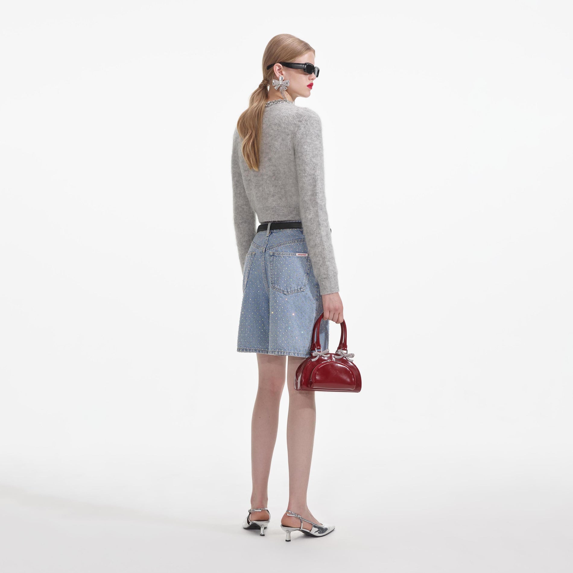 A close up of a woman wearing the Grey Soft Knit Cardigan