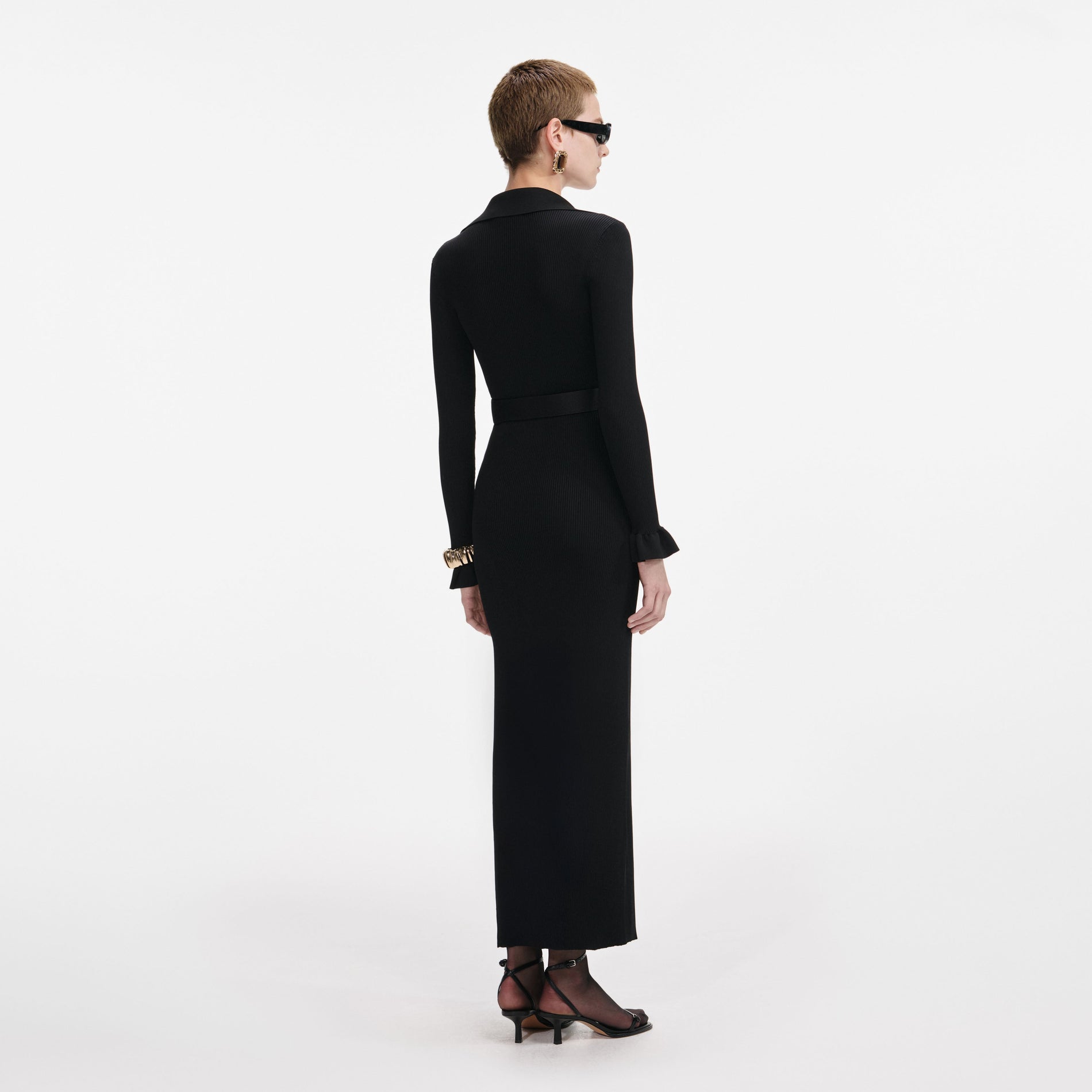 Back view of a woman wearing the Black Ribbed Knit Maxi Dress