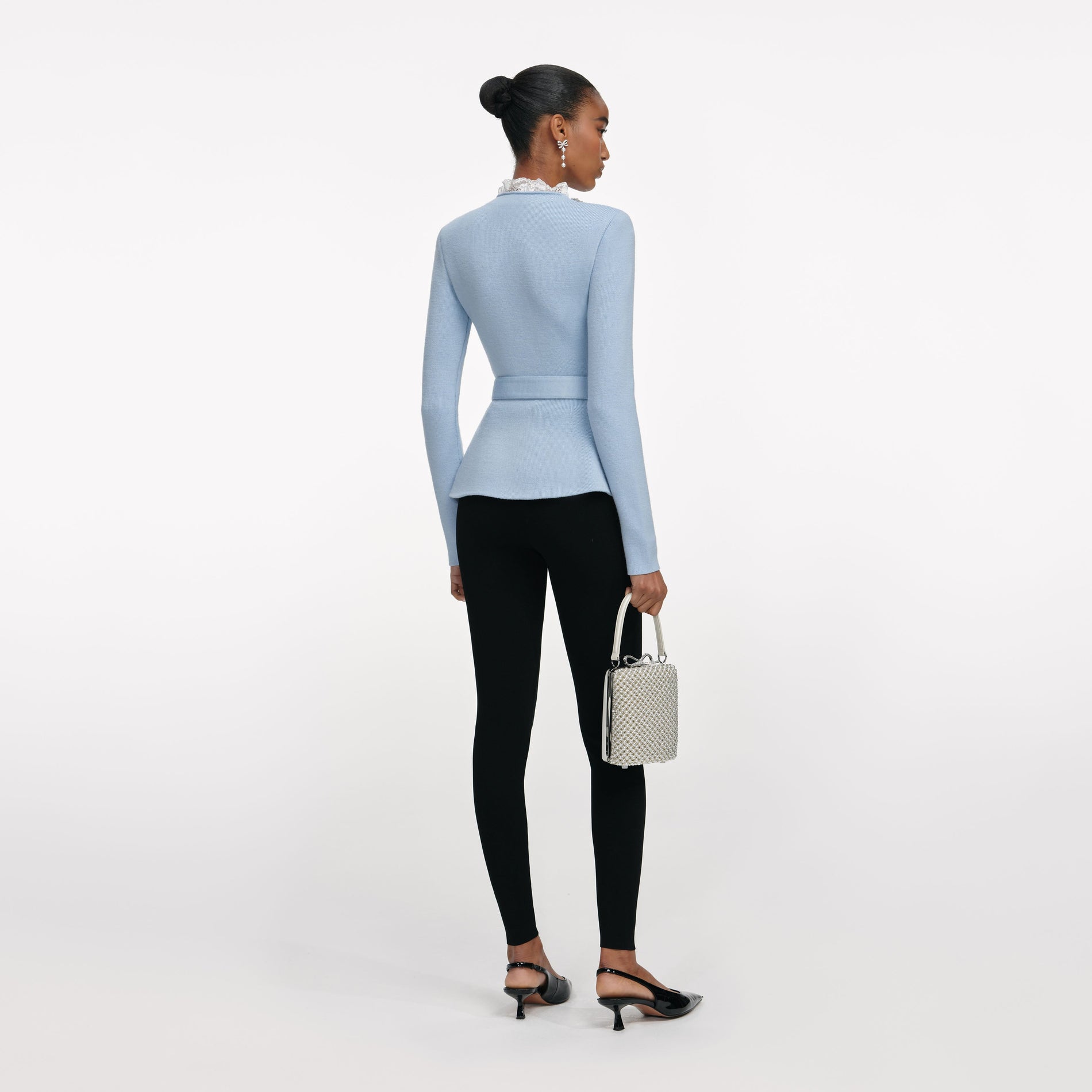 Back view of a woman wearing the Blue Crystal Trim Cardigan