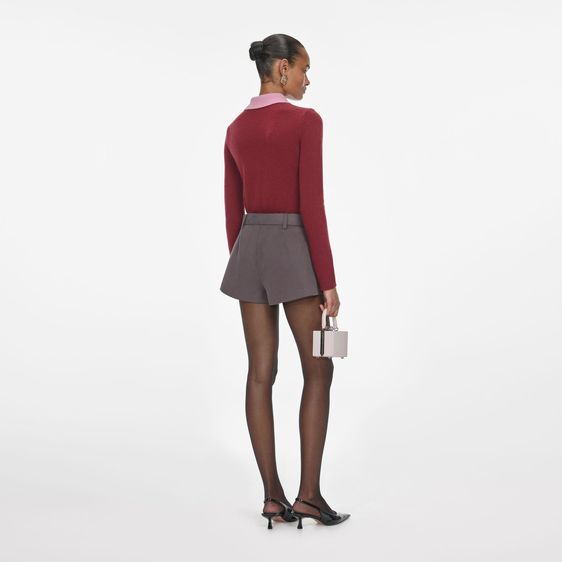 Back view of a woman wearing the Burgundy Pink Contrast Collar Knit Top