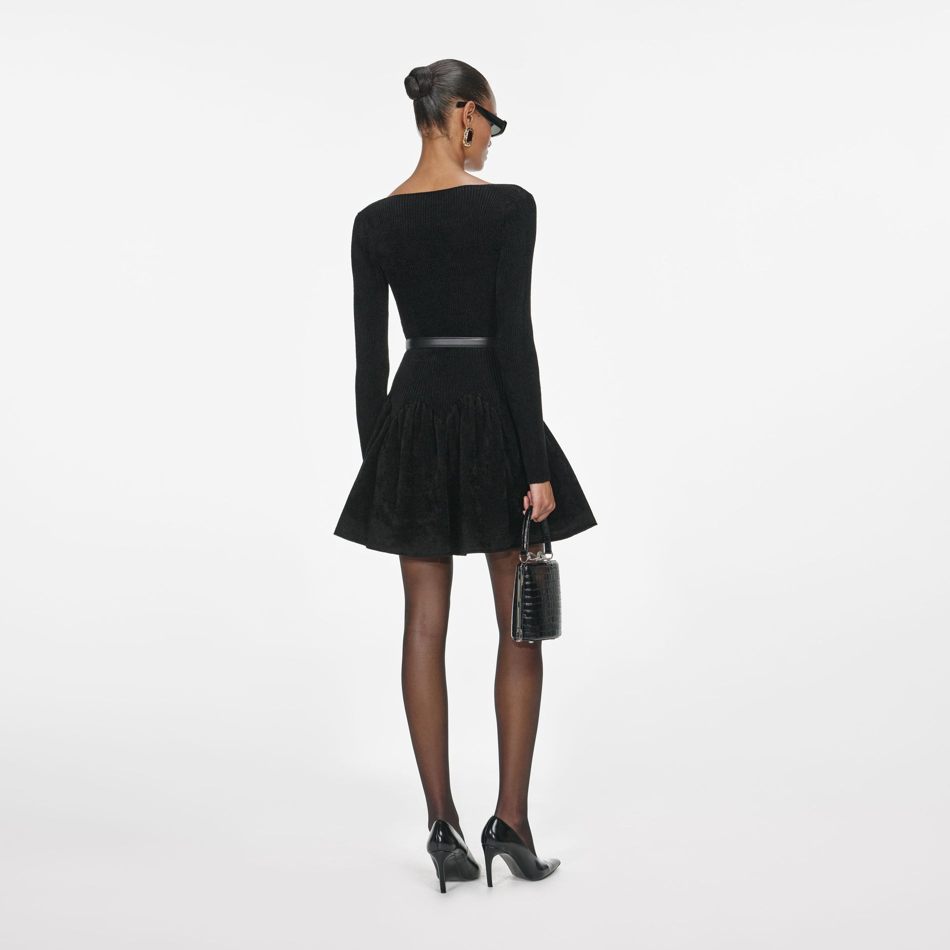 Back view of a woman wearing the Black Chenille Knit Dress