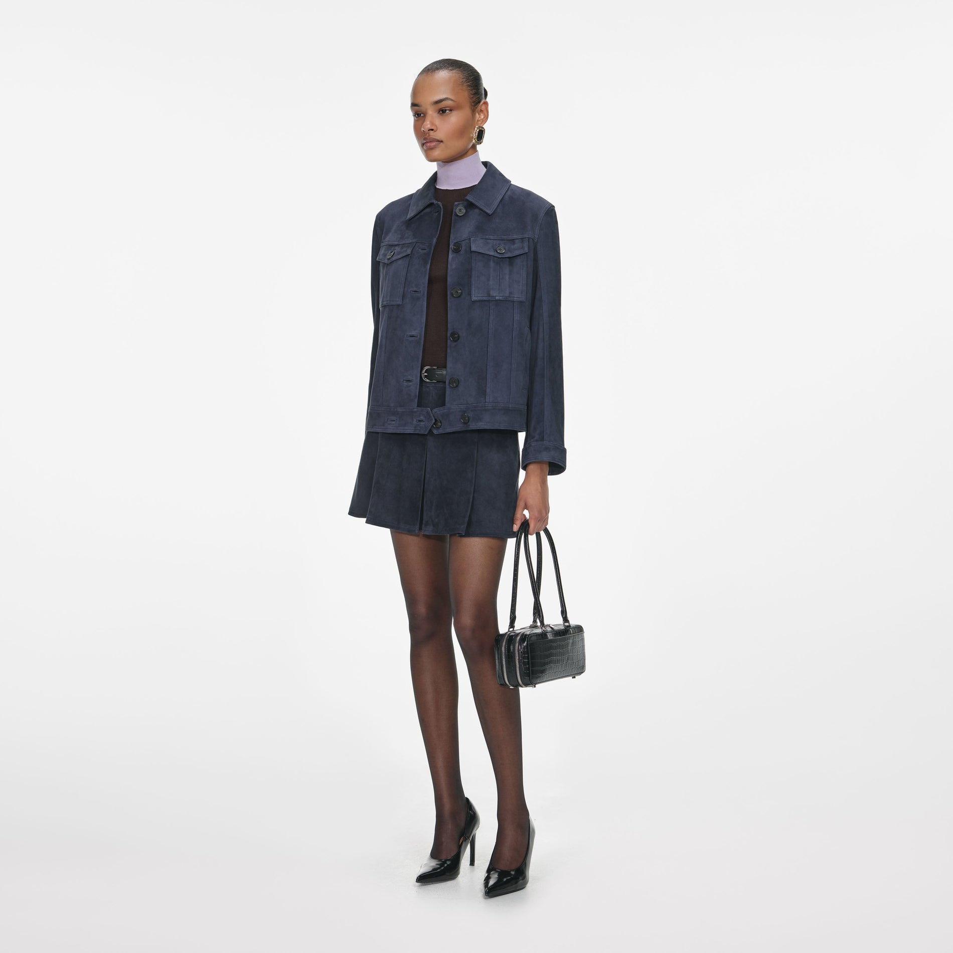 Side view of a woman wearing the Navy Suede Jacket