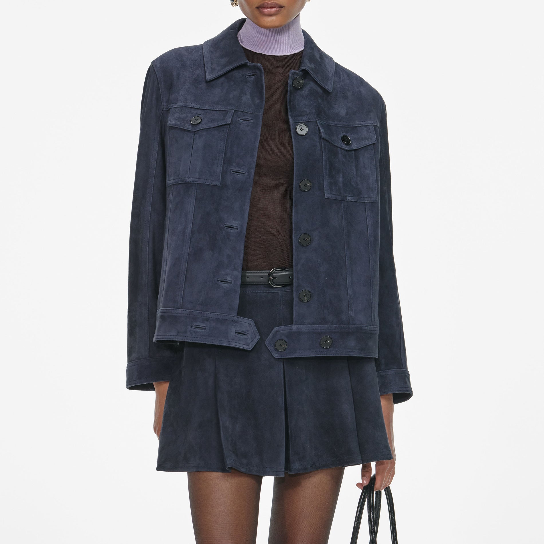 A close up of a woman wearing the Navy Suede Jacket