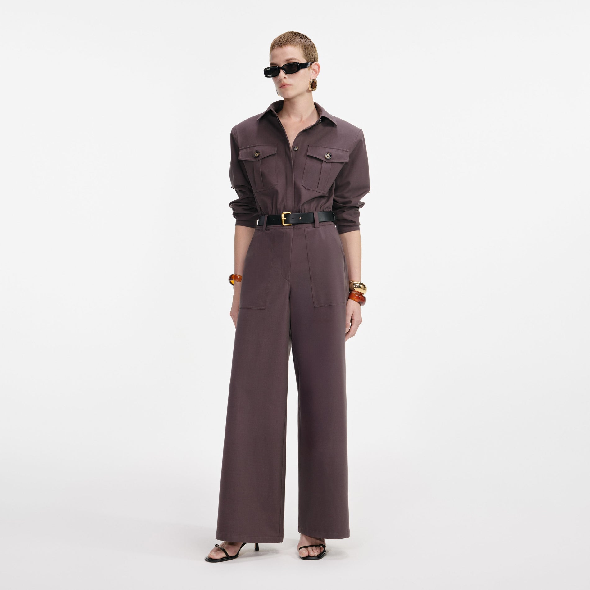 Side view of a woman wearing the Brown Twill Jumpsuit