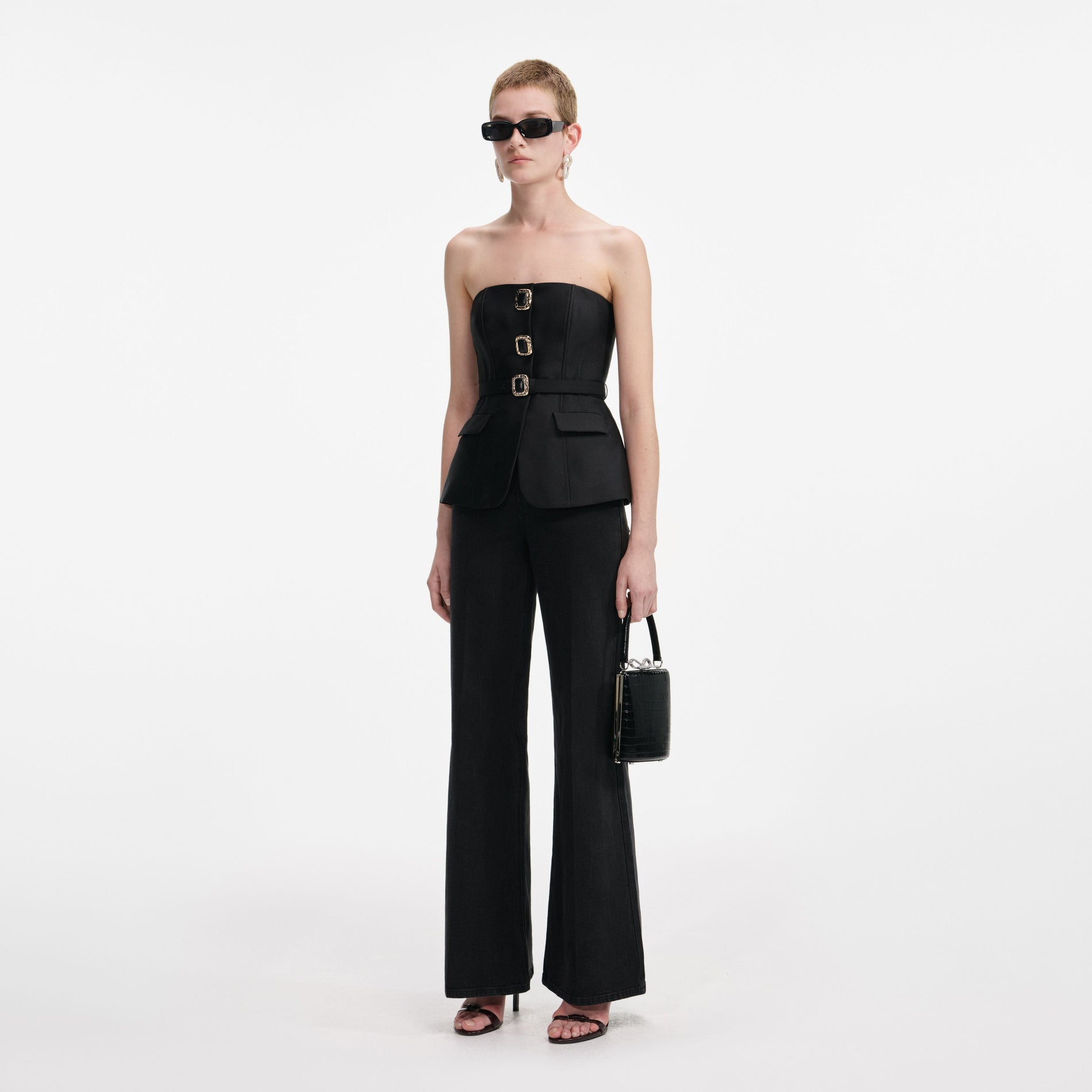 Side view of a woman wearing the Black Taffeta Bandeau Jumpsuit