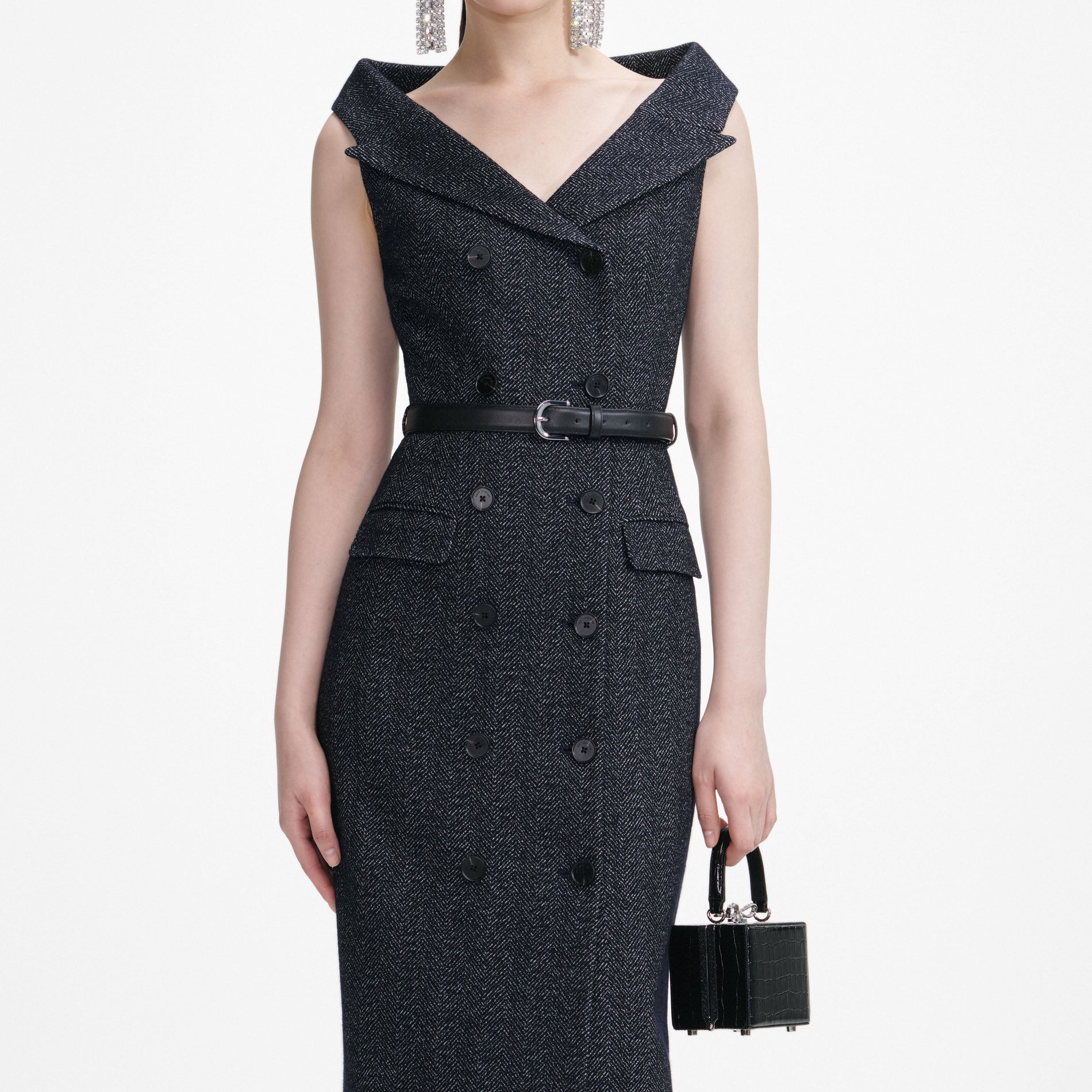 A close up of a woman wearing the Navy Herringbone Wool Midi Dress