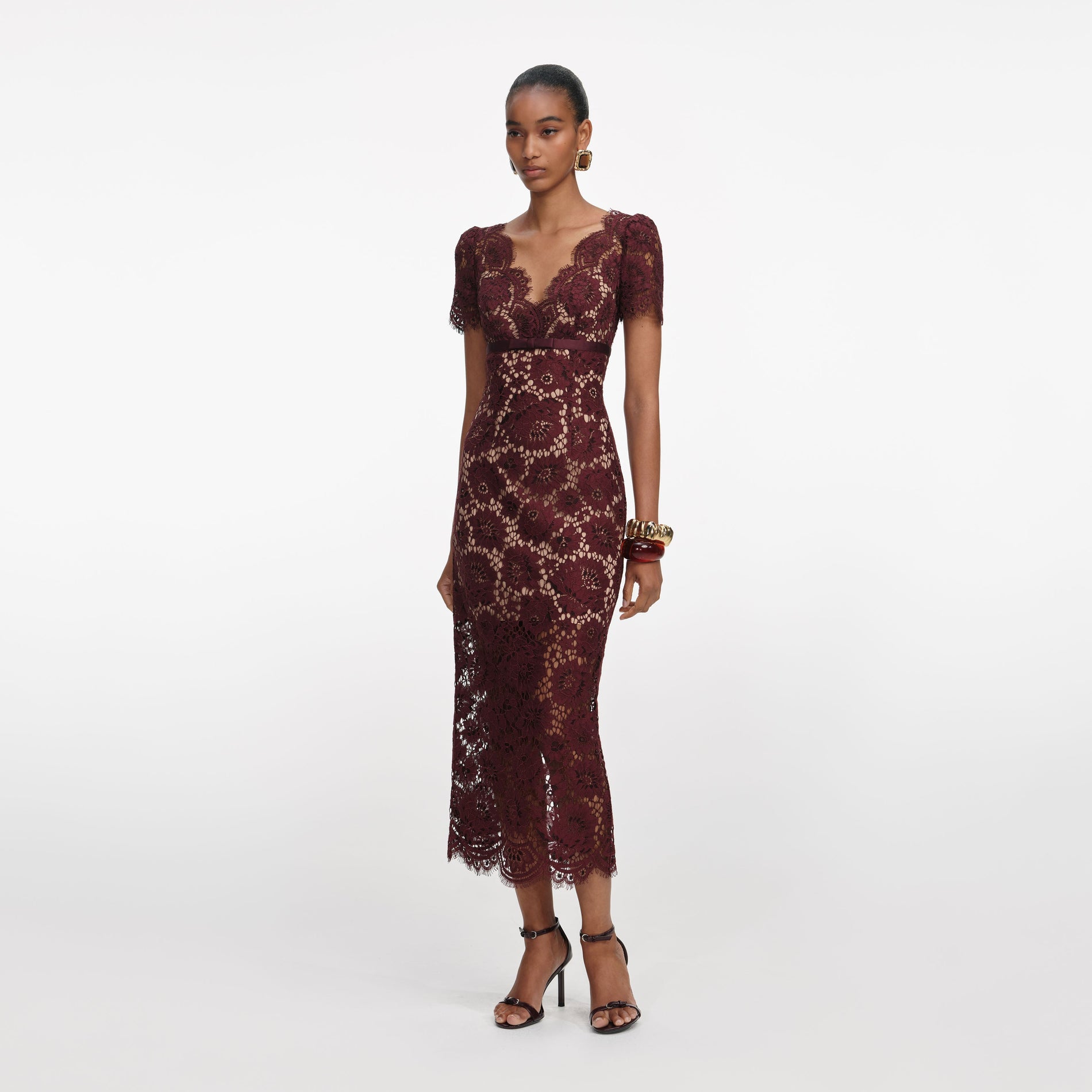 Side view of a woman wearing the Burgundy Floral Lace Midi Dress