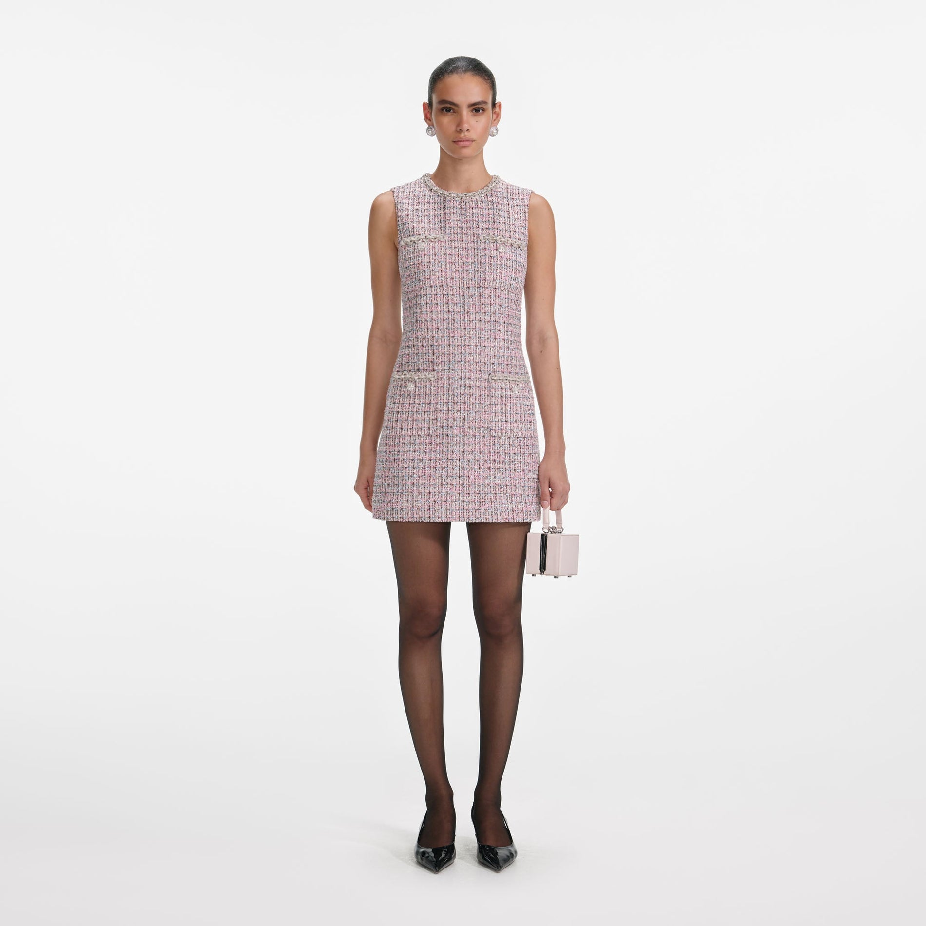 Front view of a woman wearing the Pink Boucle Sleeveless Mini Dress
