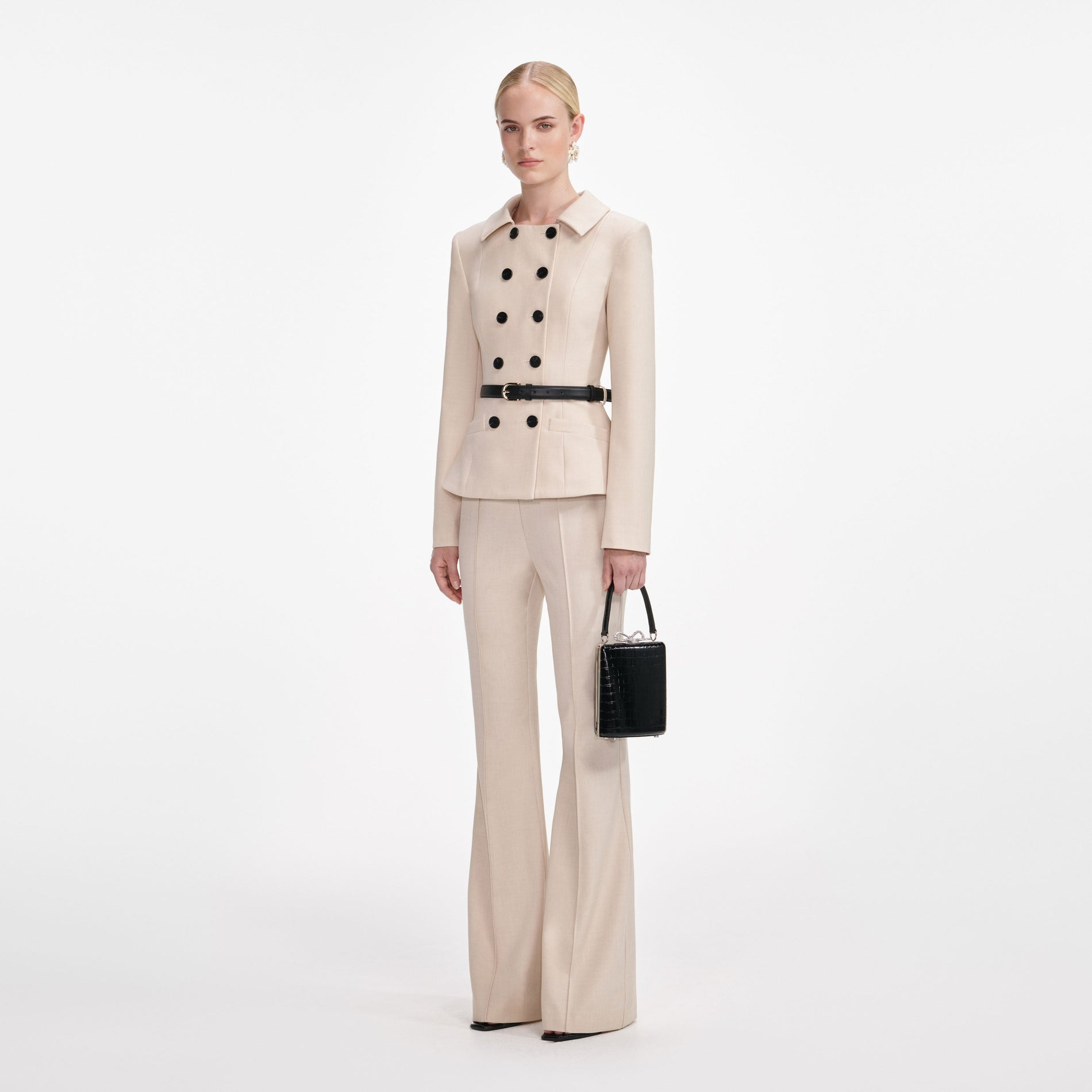Side view of a woman wearing the Beige Twill Jumpsuit