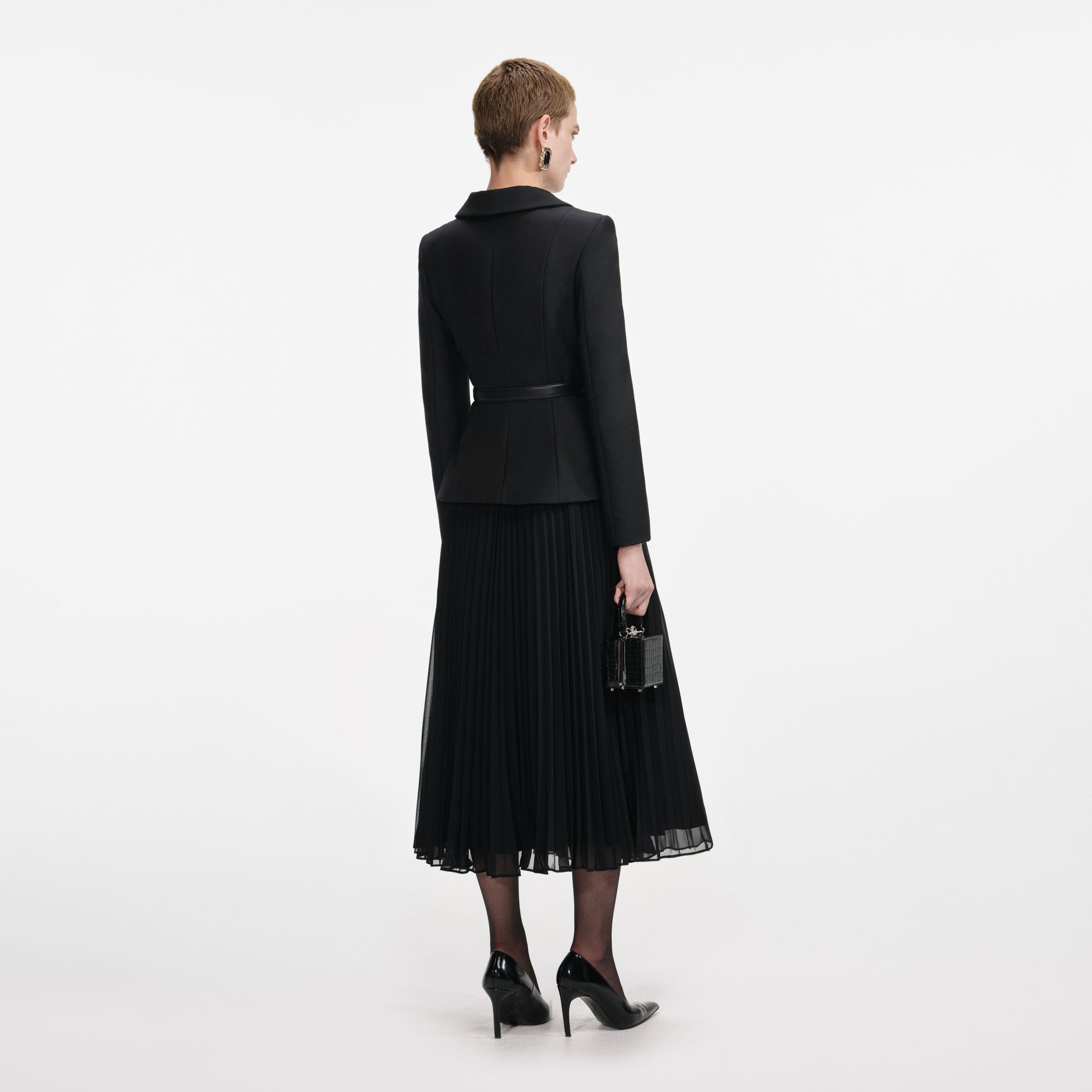 Back view of a woman wearing the Black Wool Crepe Midi Dress