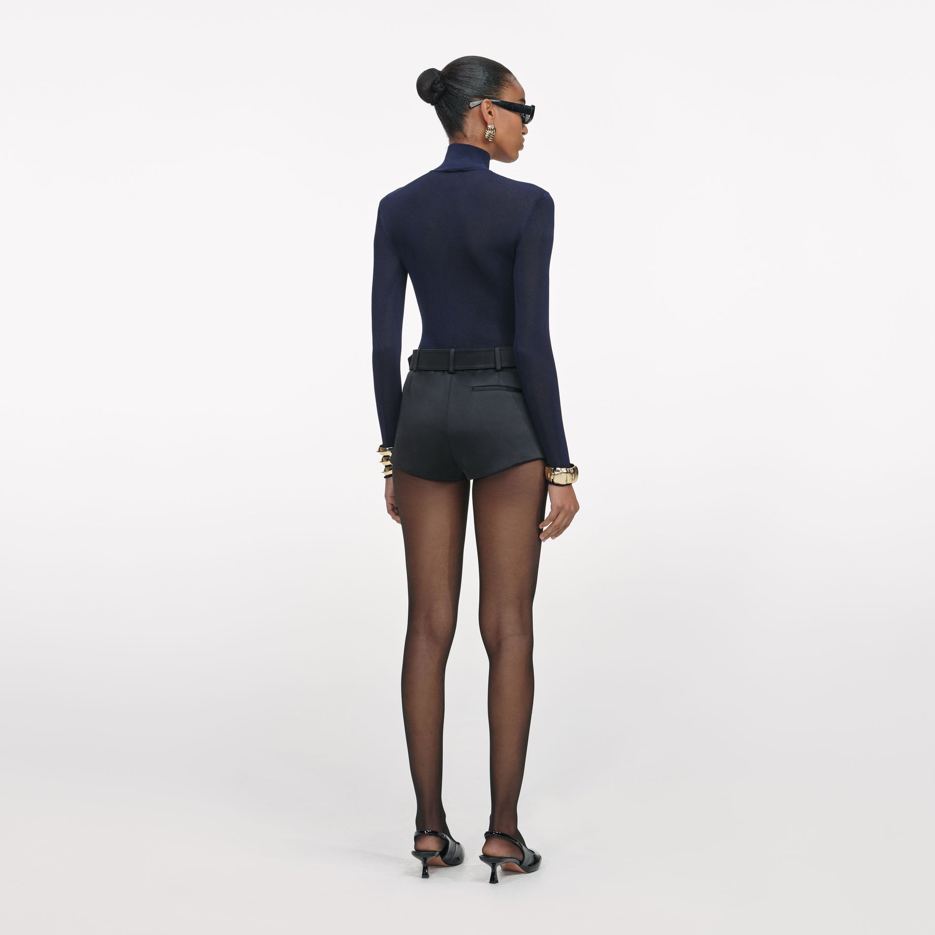 Back view of a woman wearing the Black Satin Shorts