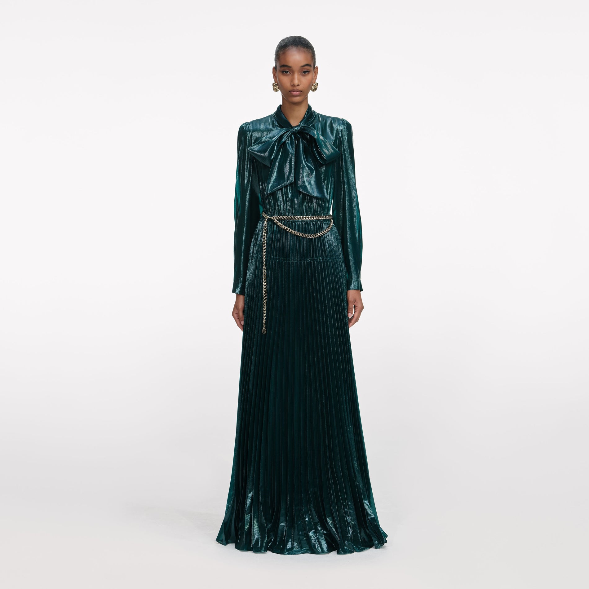 Front view of a woman wearing the Green Metallic Pussy Bow Maxi Dress