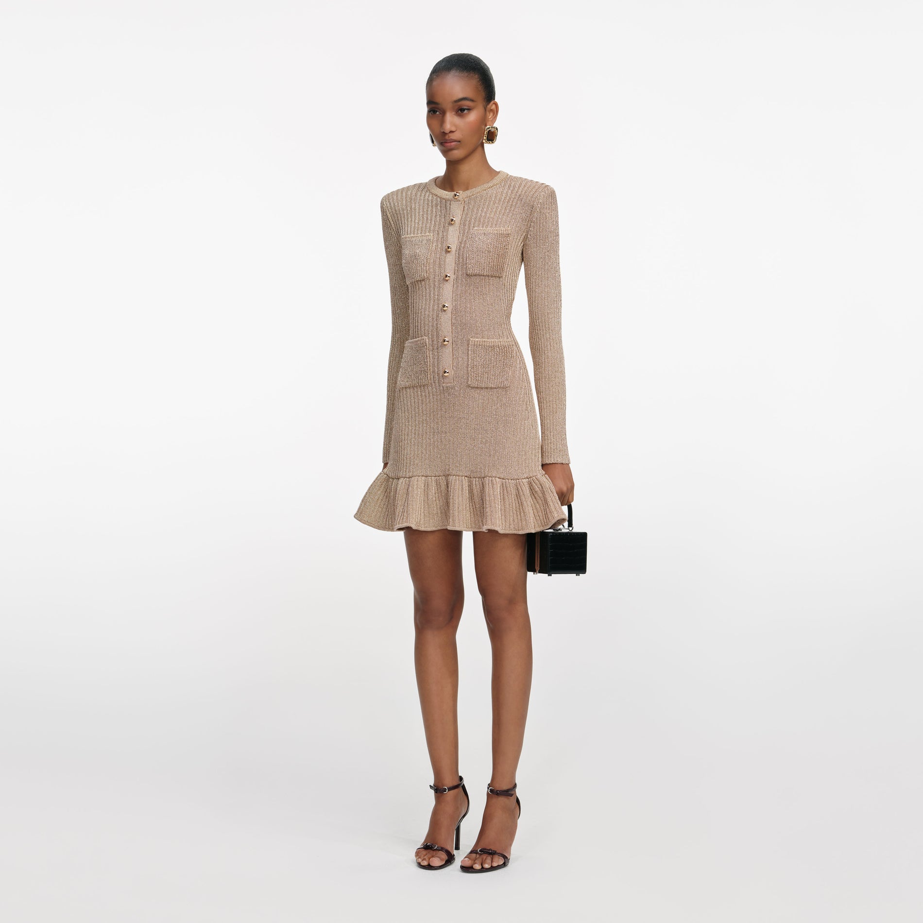 Side view of a woman wearing the Gold Lurex Knit Mini Dress