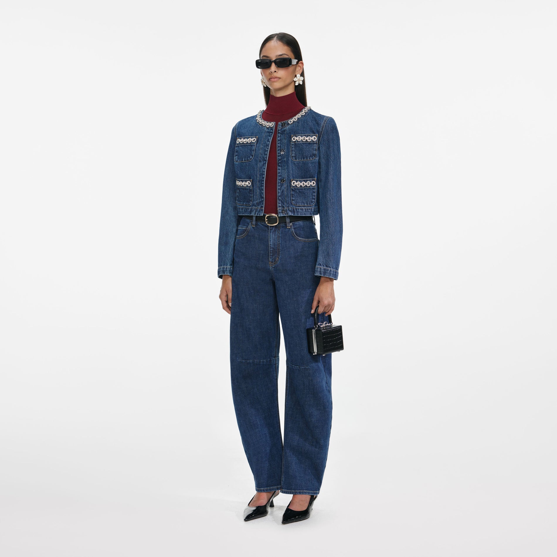 Side view of a woman wearing the Crystal Trim Denim Jacket