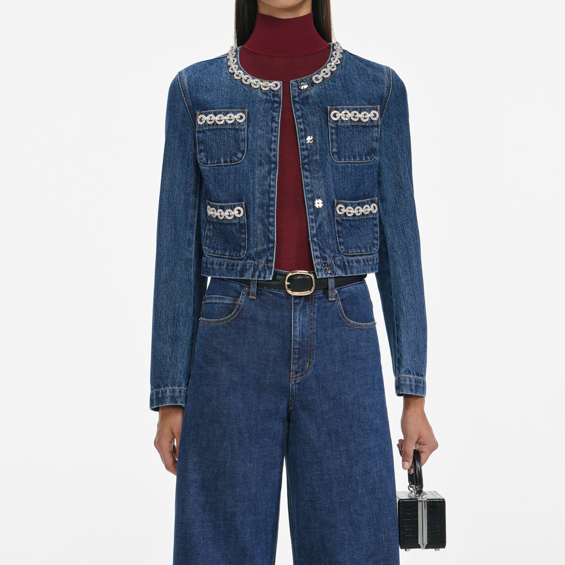 A close up of a woman wearing the Crystal Trim Denim Jacket