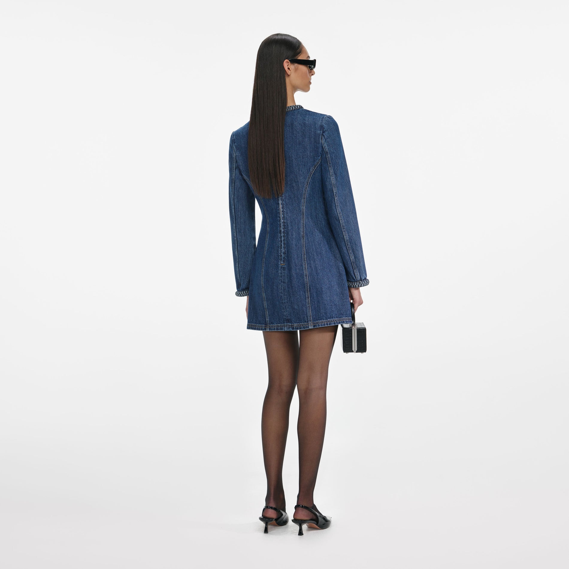 Back view of a woman wearing the Denim Braided Mini Dress