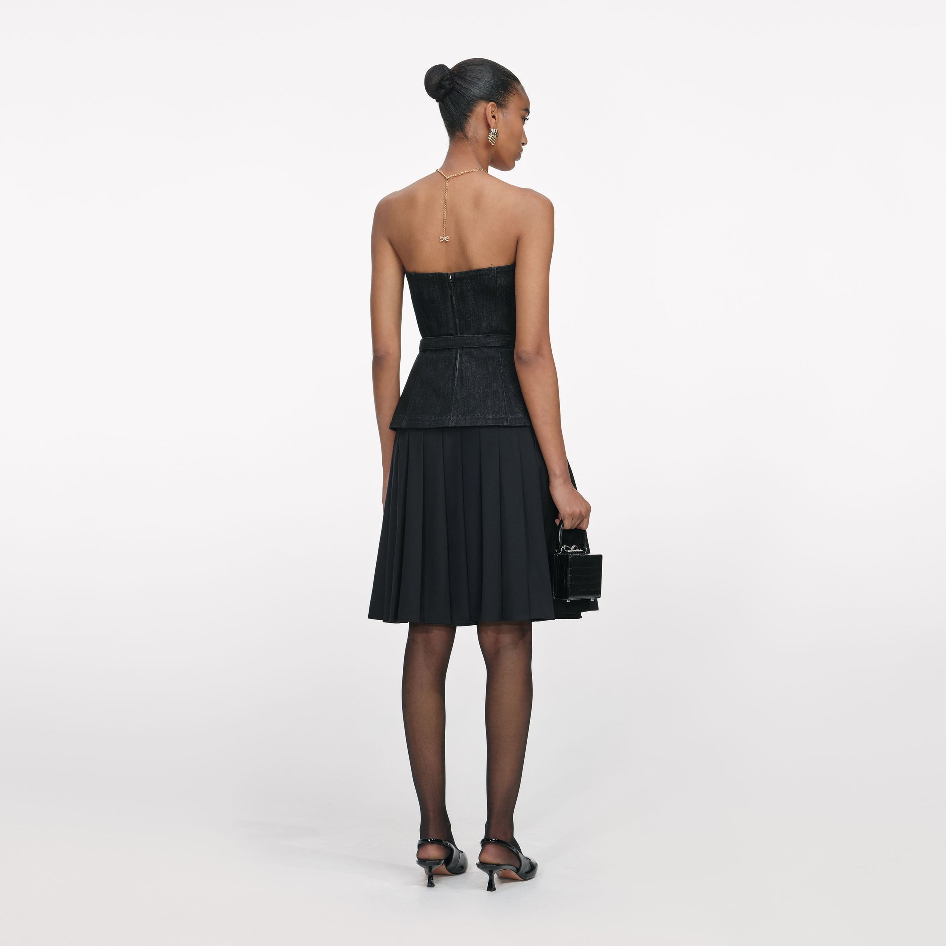 Back view of a woman wearing the Black Denim Bandeau Top