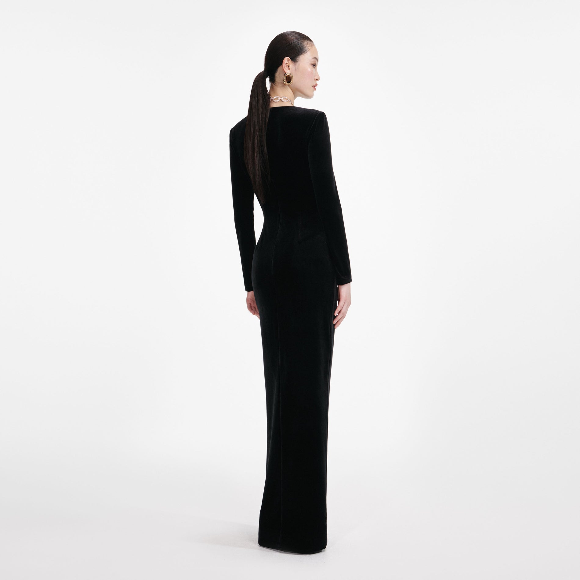 Back view of a woman wearing the Black Velvet Embellished Maxi Dress