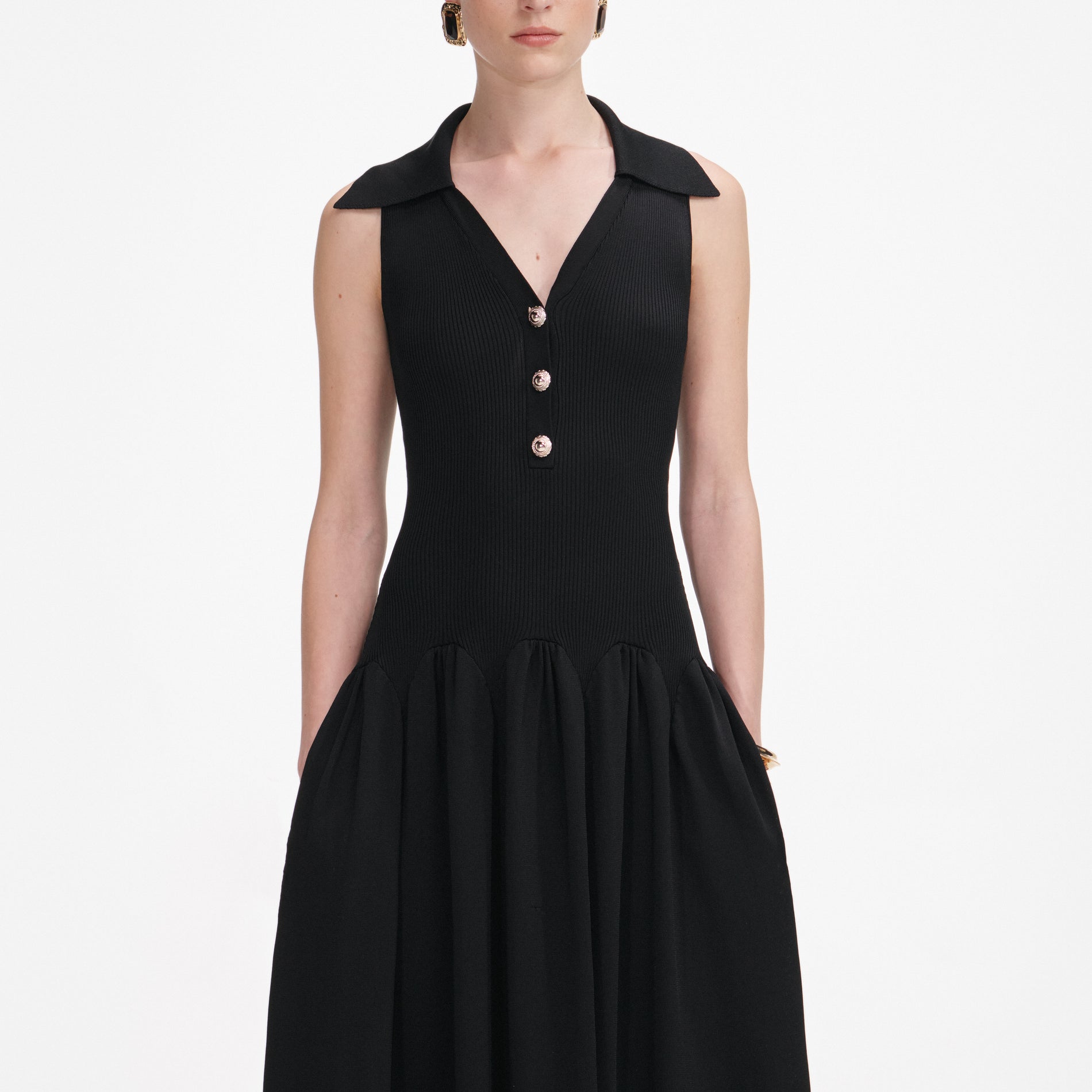 A close up of a woman wearing the Black Ribbed Knit Midi Dress