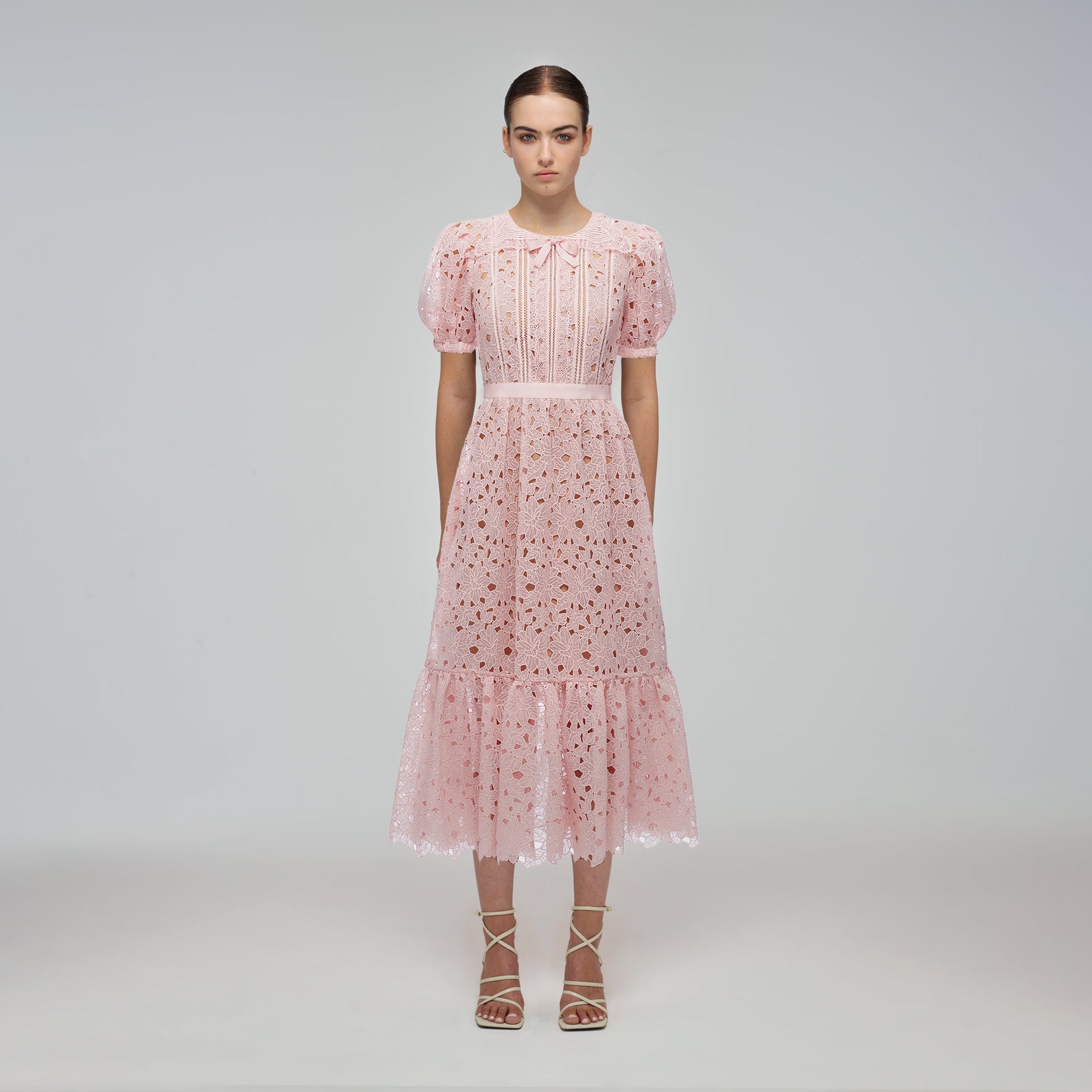 A woman wearing the Blush Guipure Midi Dress
