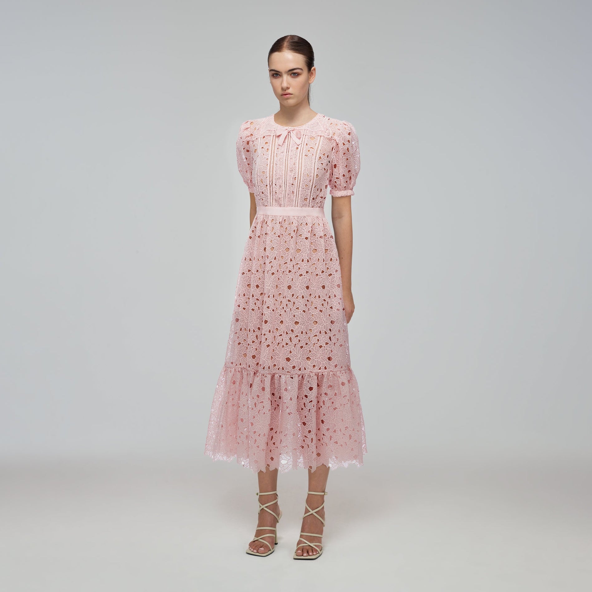 A woman wearing the Blush Guipure Midi Dress