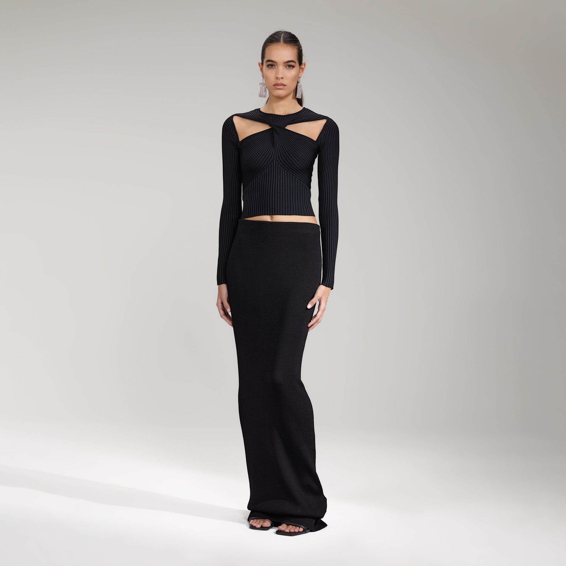 A woman wearing the Black Ribbed Knit Cut Out Top