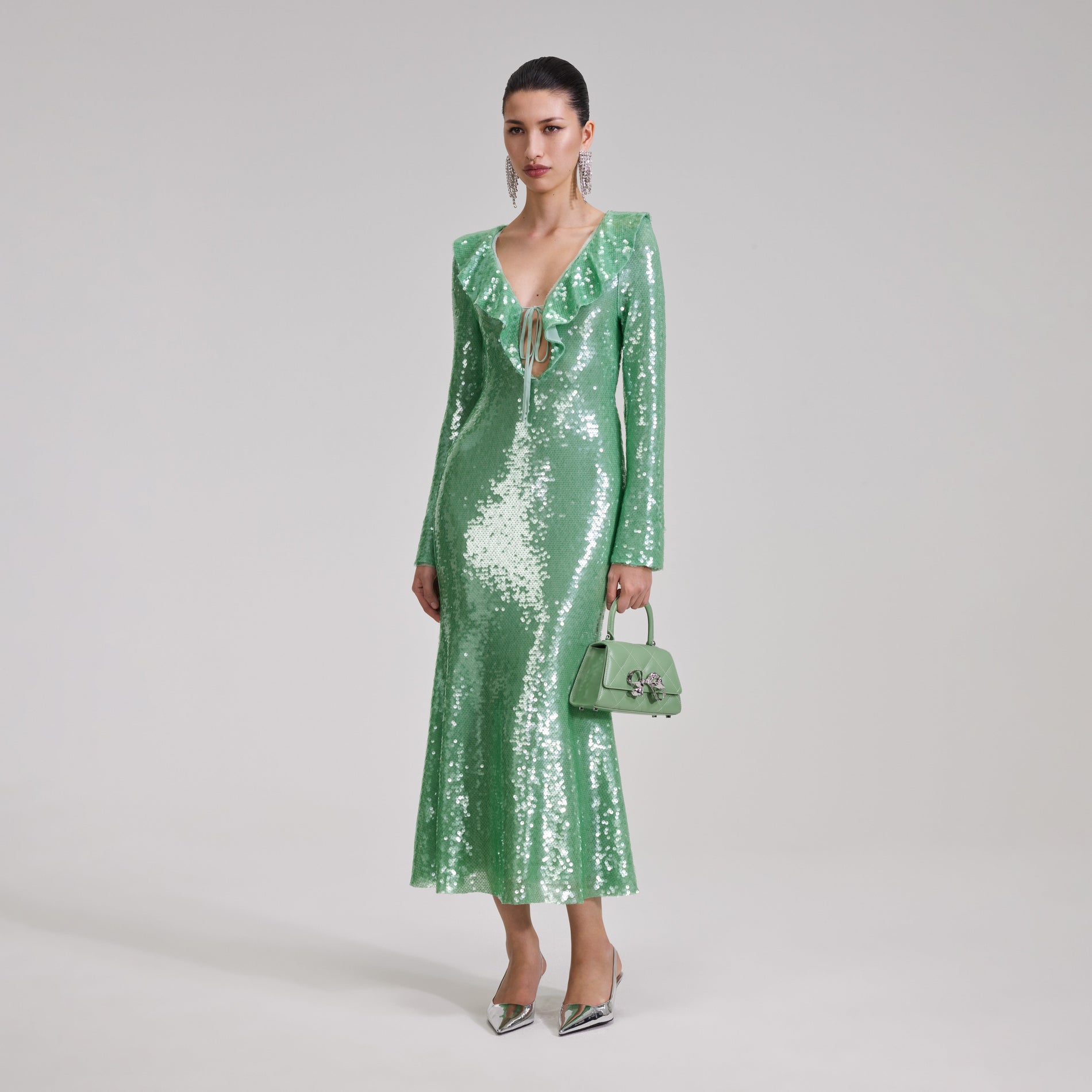 A woman wearing the Green Sequin Midi Dress