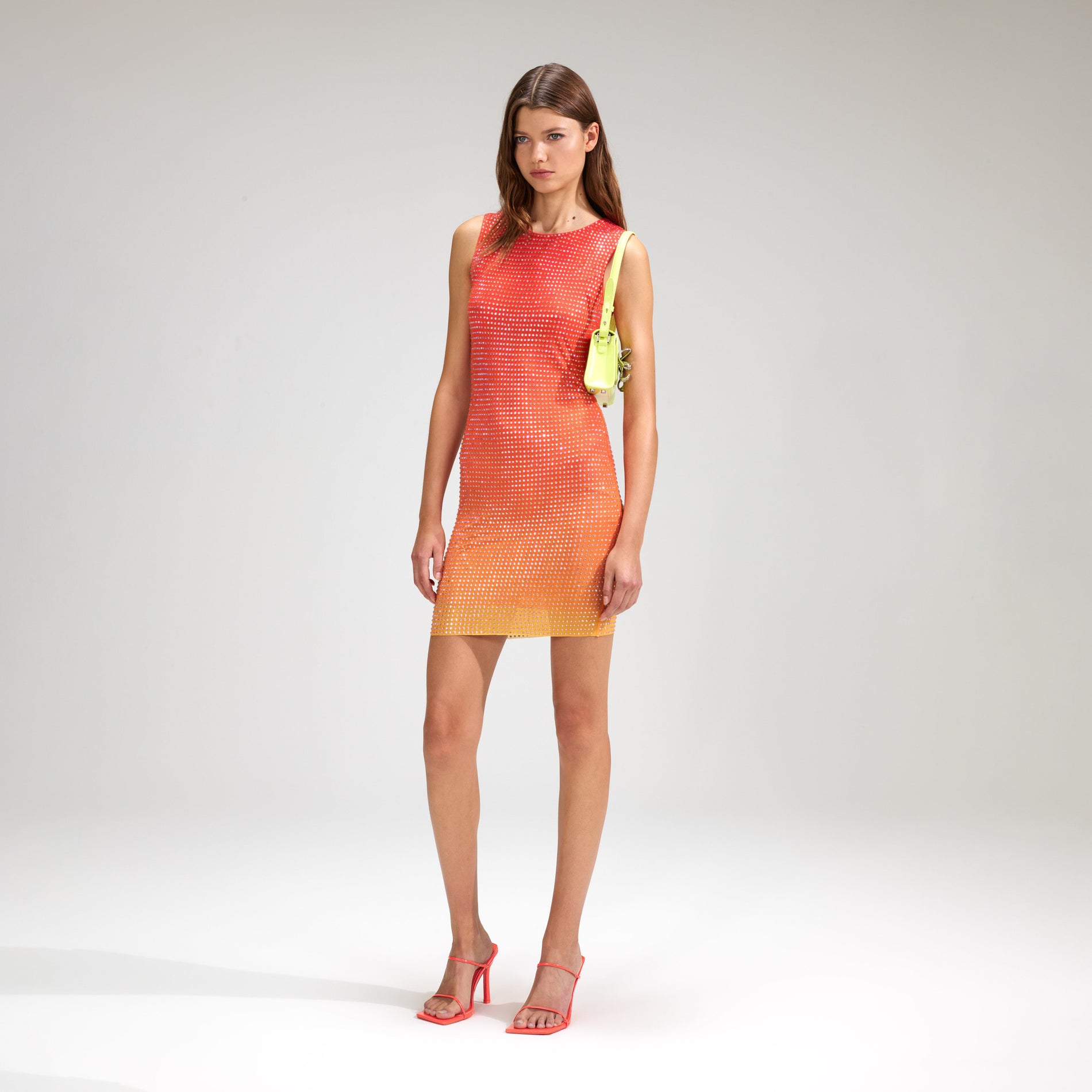 A woman wearing the Pink Rhinestone Mesh Mini Dress