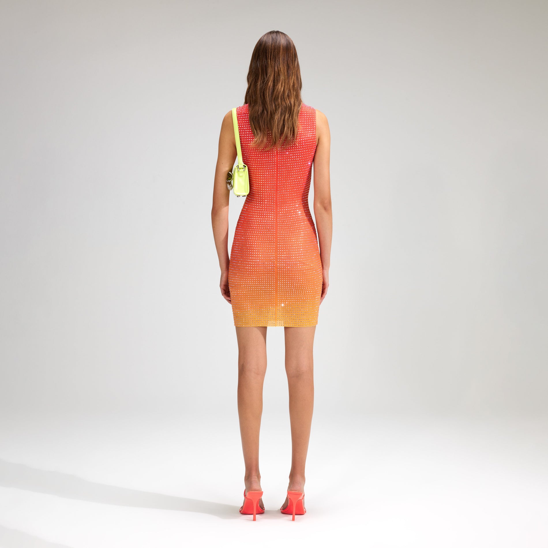 A woman wearing the Pink Rhinestone Mesh Mini Dress