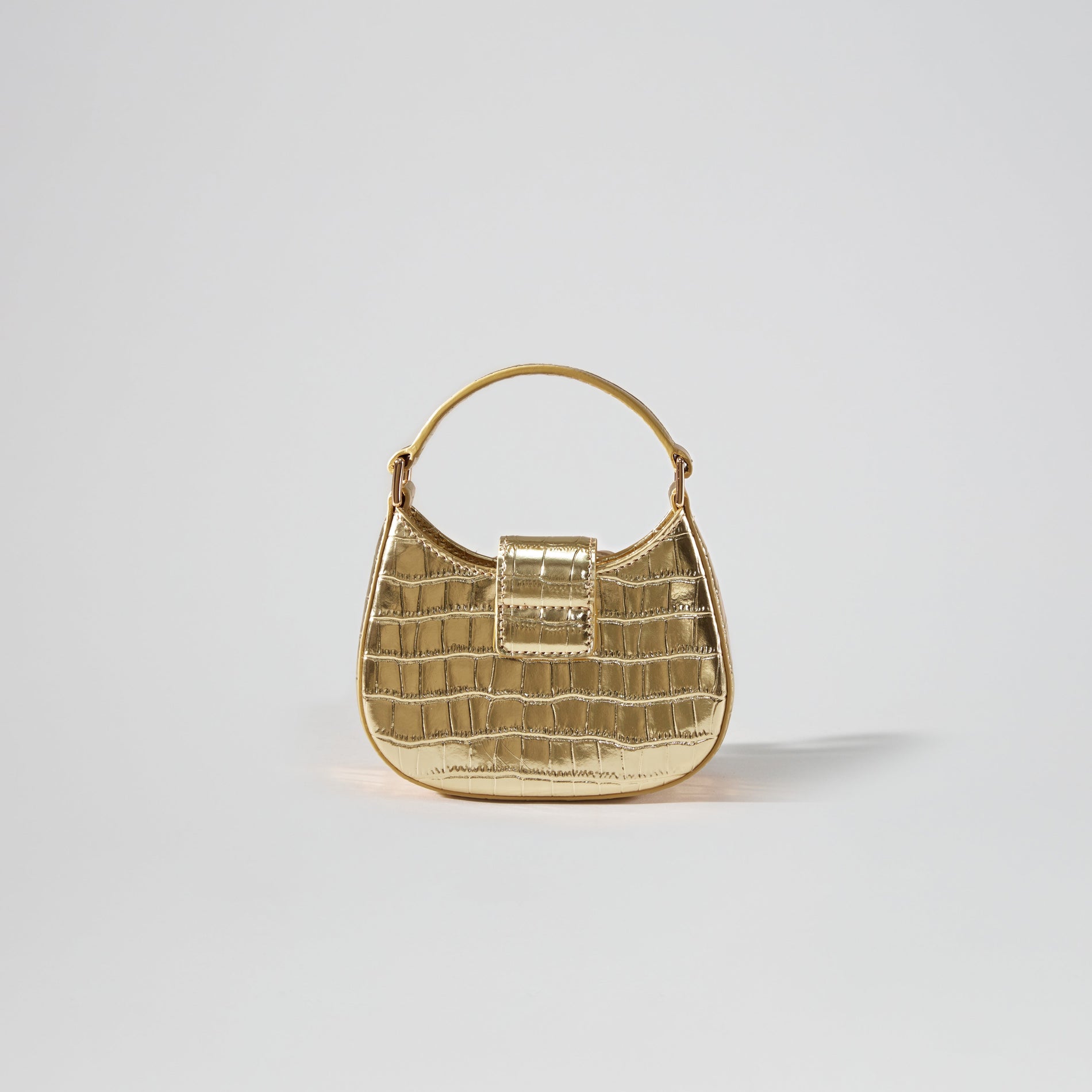 Back view of a woman wearing the Gold Croc Crescent Bow Micro Bag