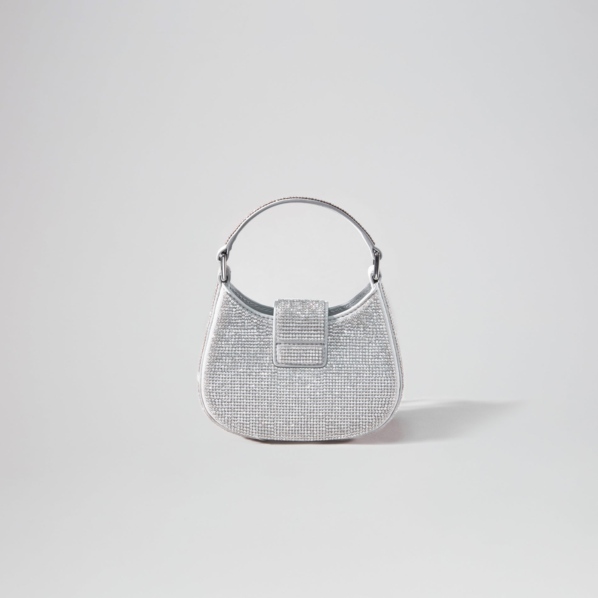 Back view of a woman wearing the Silver Rhinestone Crescent Bow Micro Bag