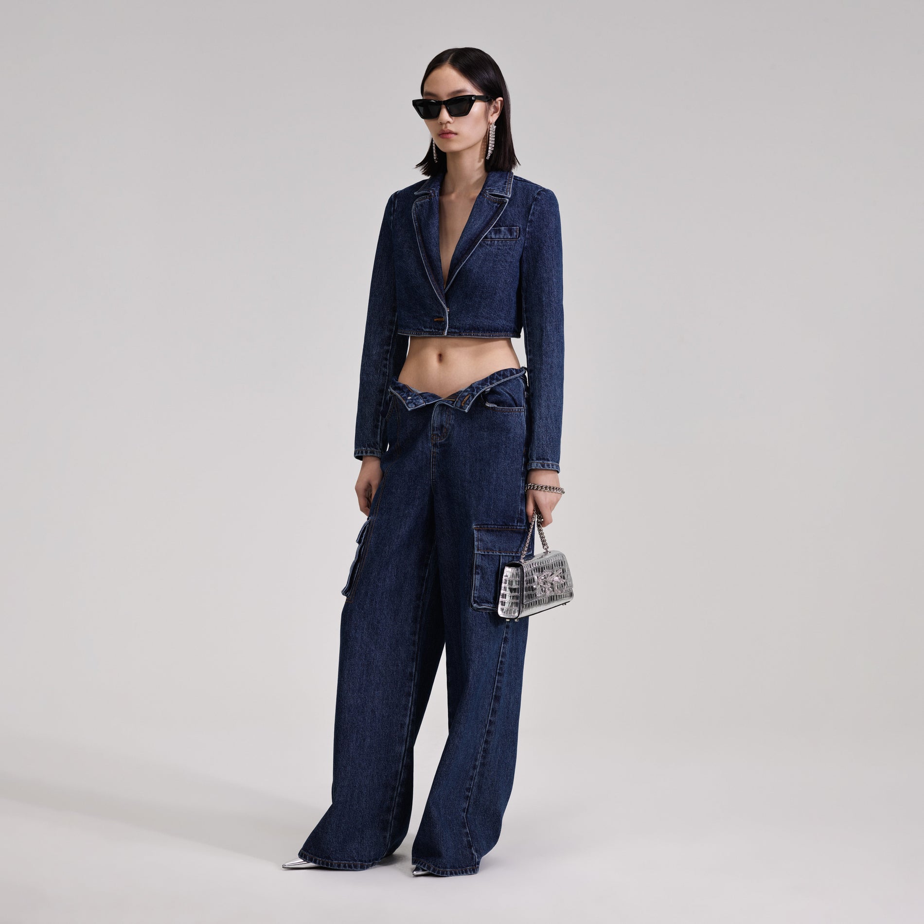 A woman wearing the Cropped Denim Jacket